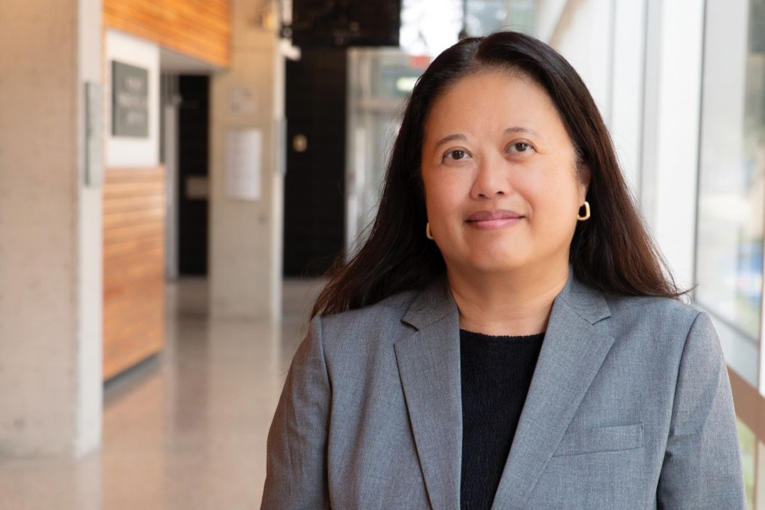 Portrait of Dr. Hope Anderson in a hallway in the pharmacy building. 