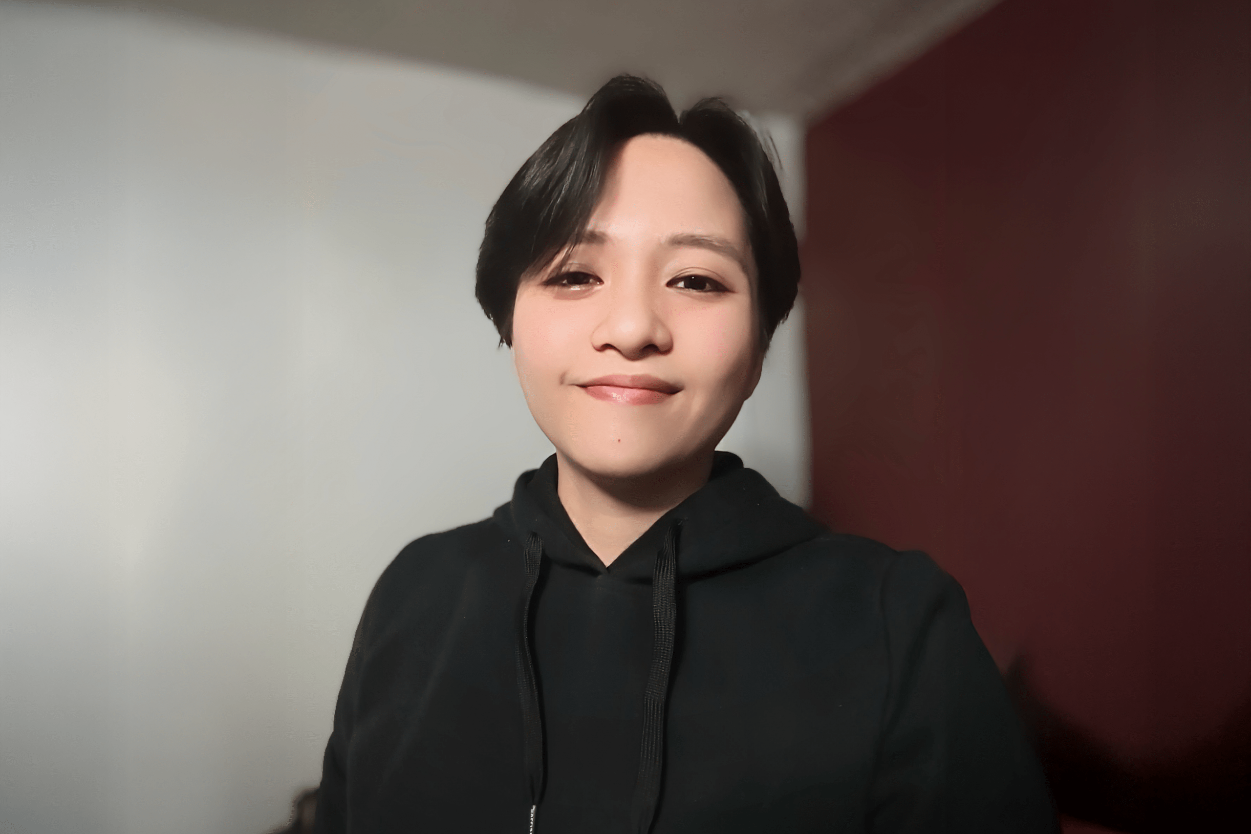 Student with short dark hair smiling for a picture