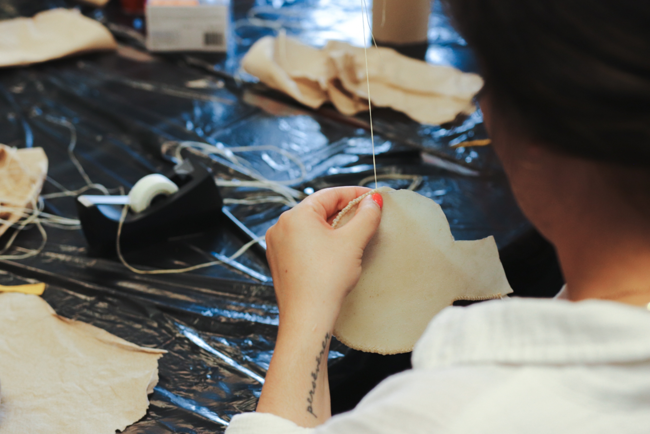 A person making a traditional Indigenous rattle.
