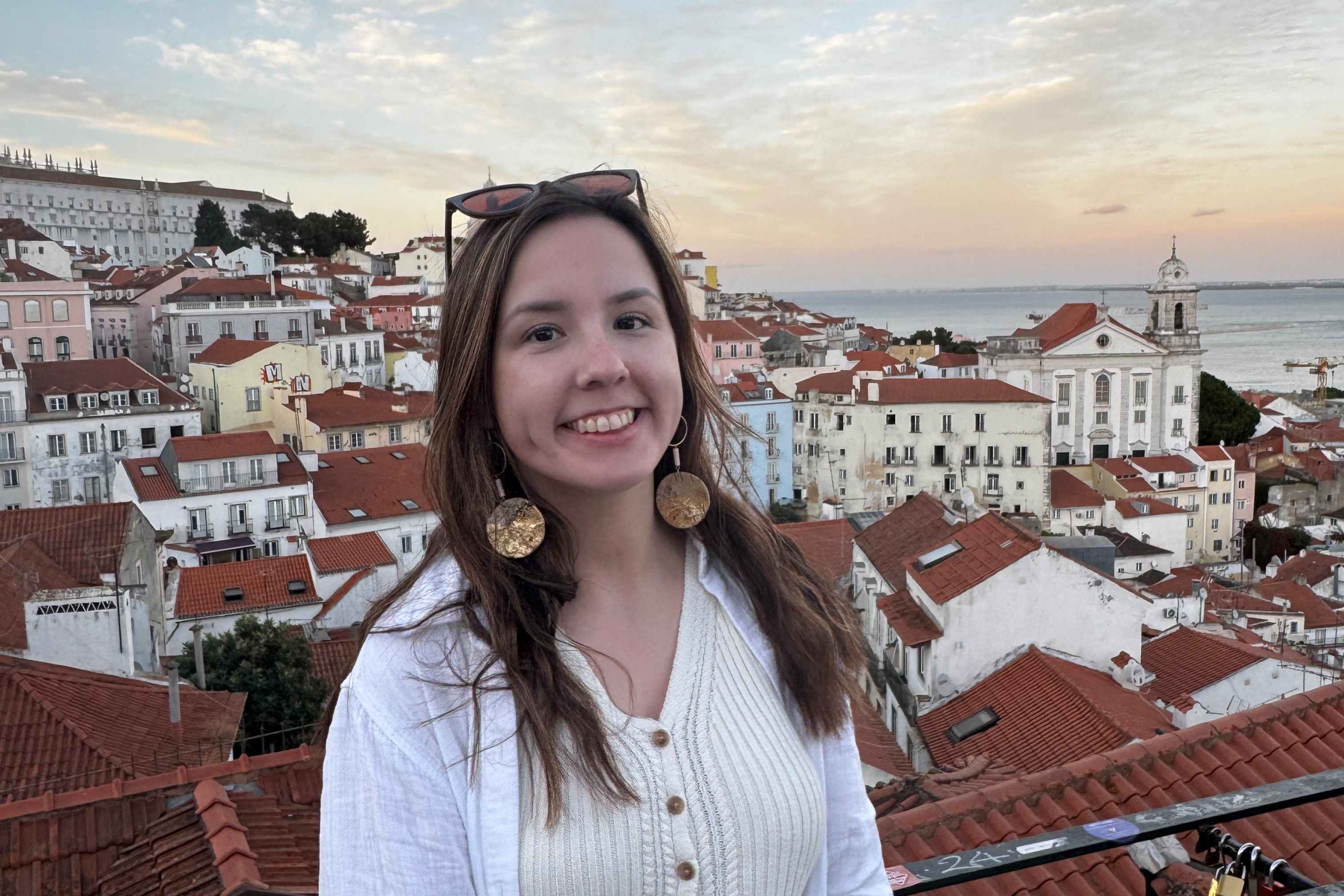 Female smiles for portrait with sunset background. 