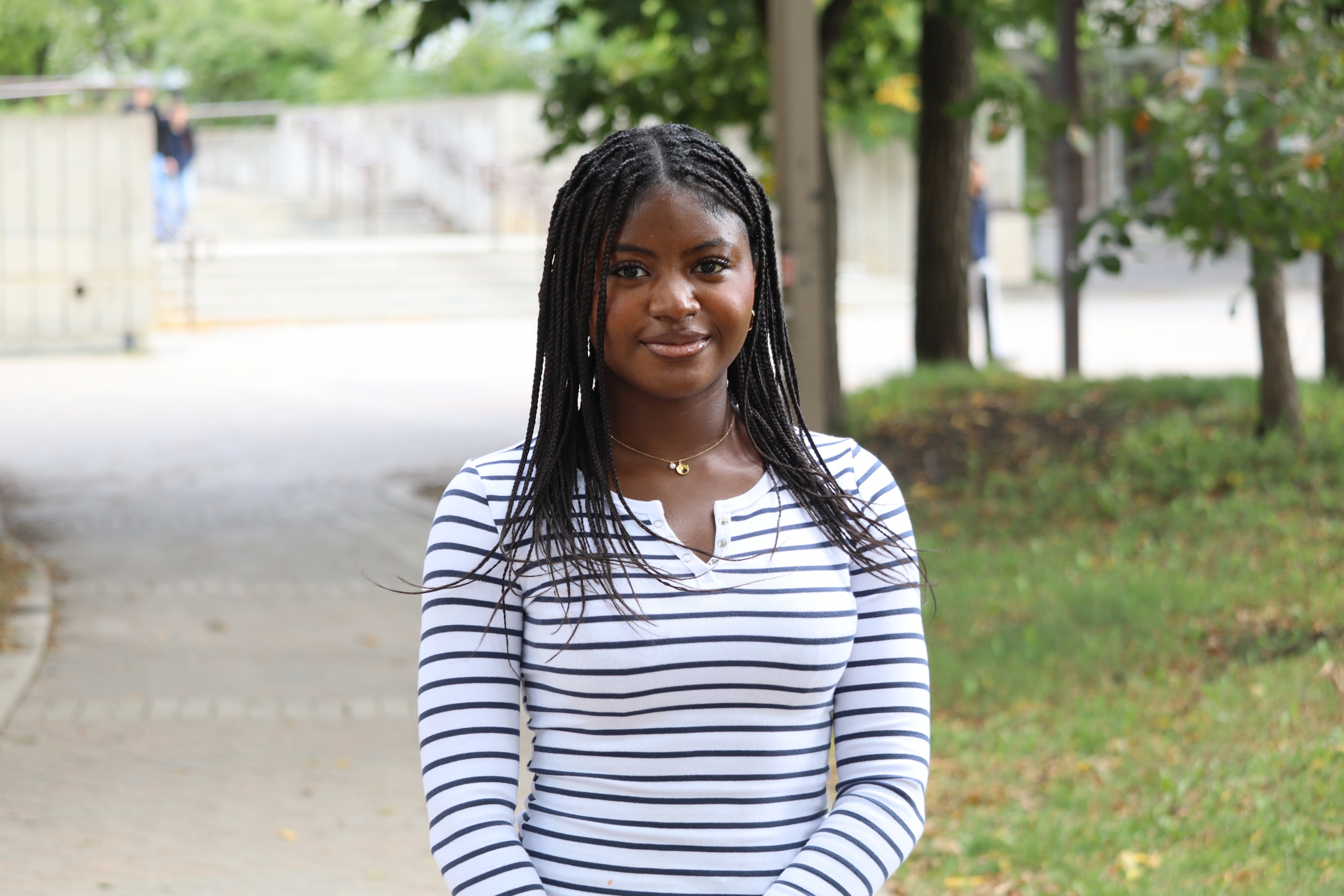 Rereloluwa Oluwadare standing outside at the Fort Garry Campus.