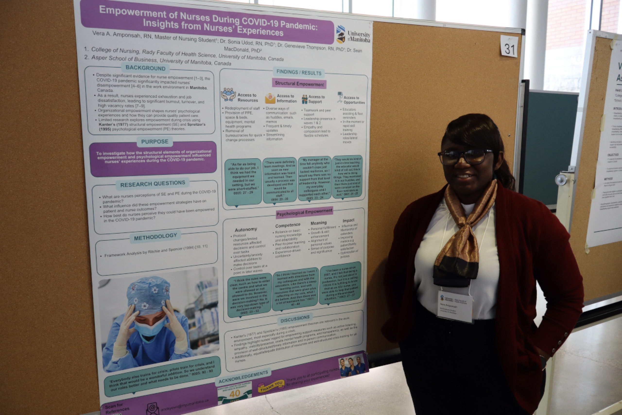 Vera Amponsah stands next to her research poster. 