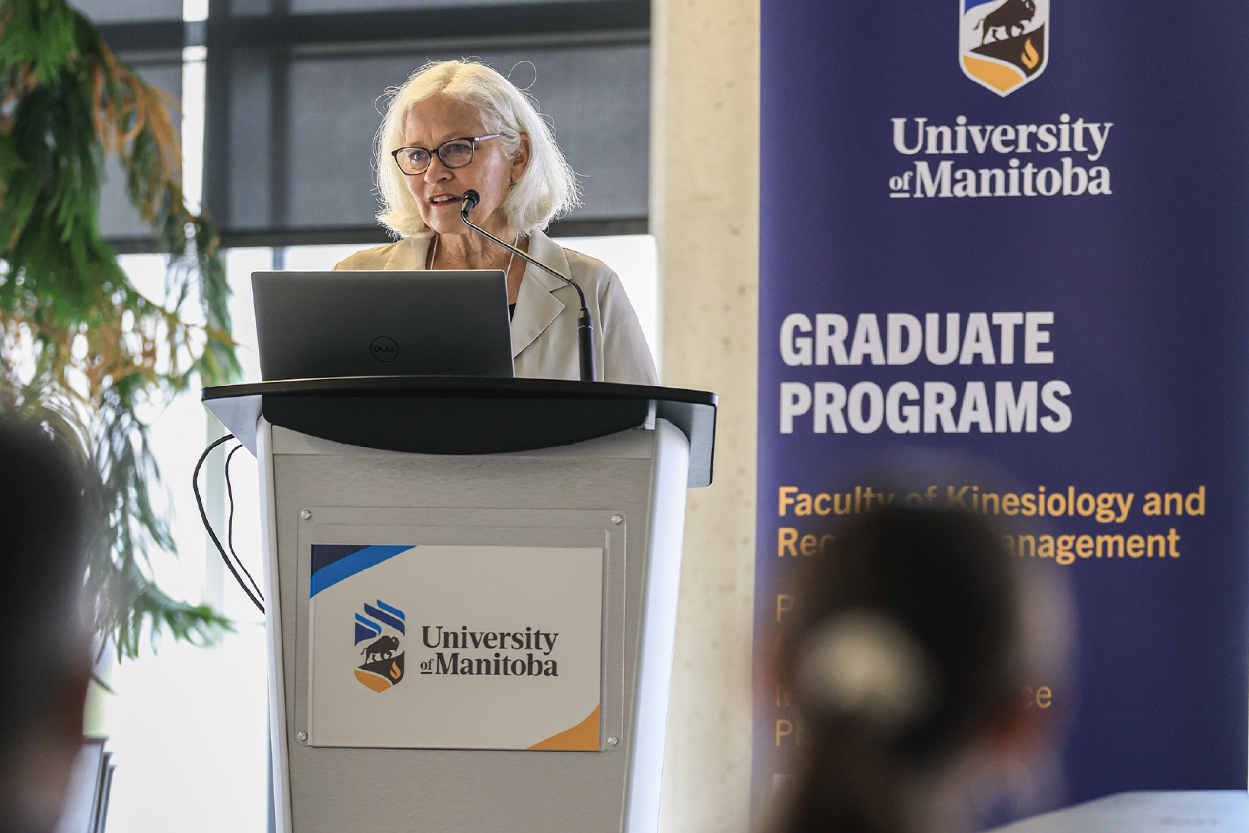 Dr. Lise Olsen speaking in front of a crowd at Research Day 2026