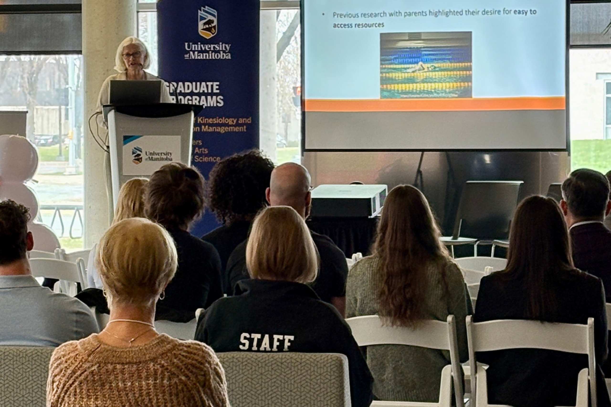 Dr. Lise Olsen speaking in front of a crowd at Research Day 2026