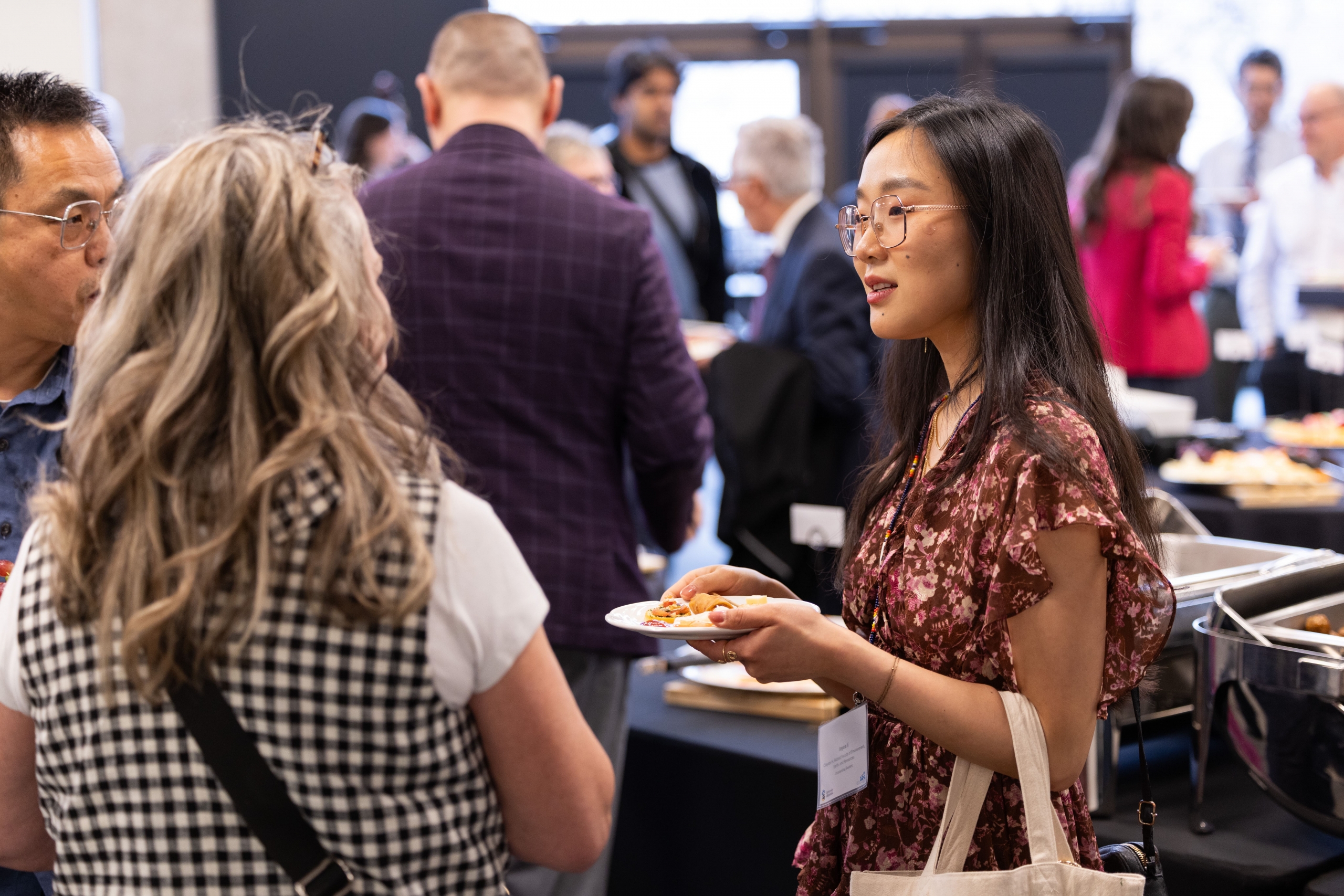 Joyce Ji is having a conversation with her educator, Ms. Leslie Goodman while enjoying snacks and refreshments.