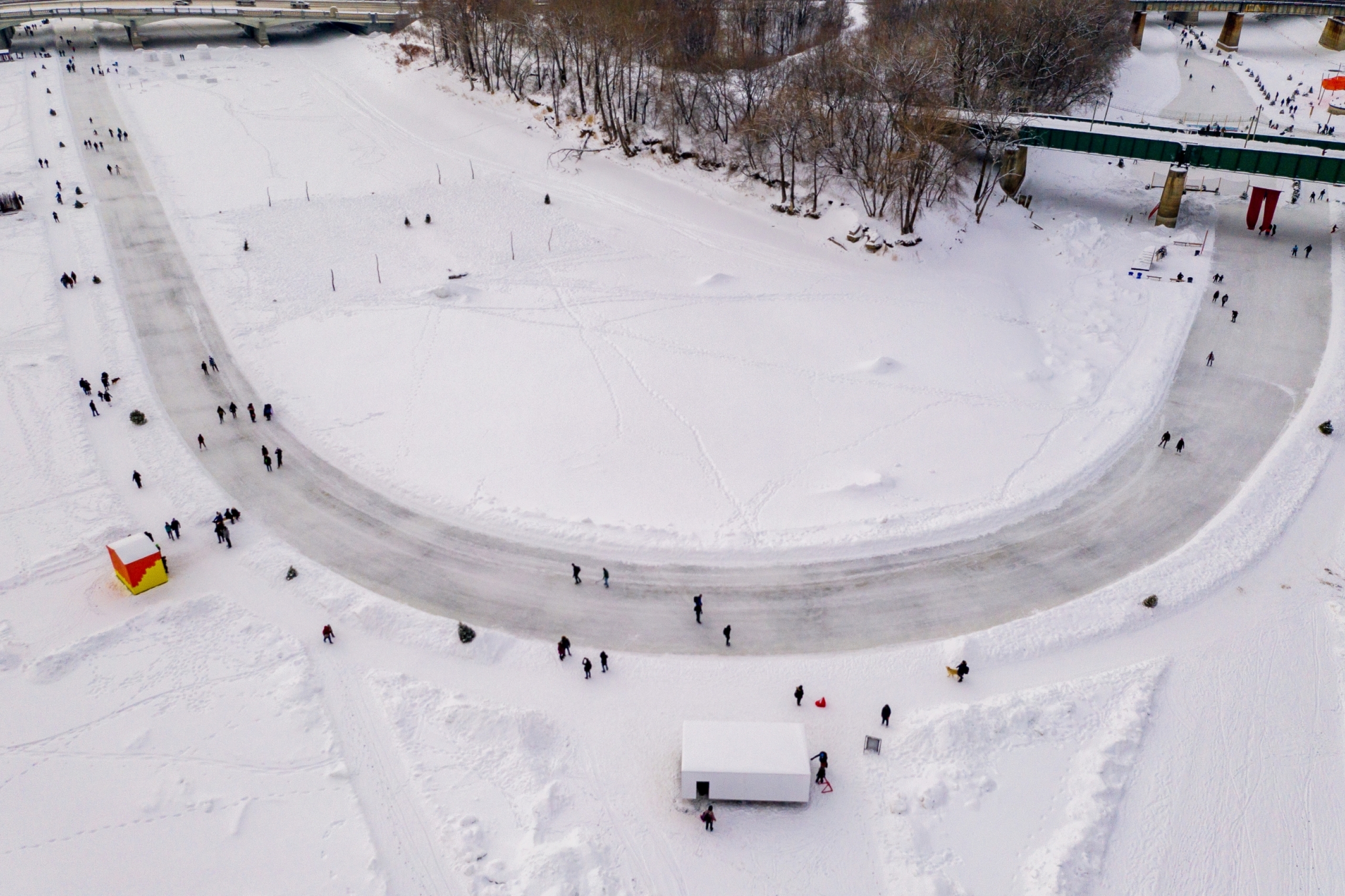 Aerial photo of people using a winter river trail. 