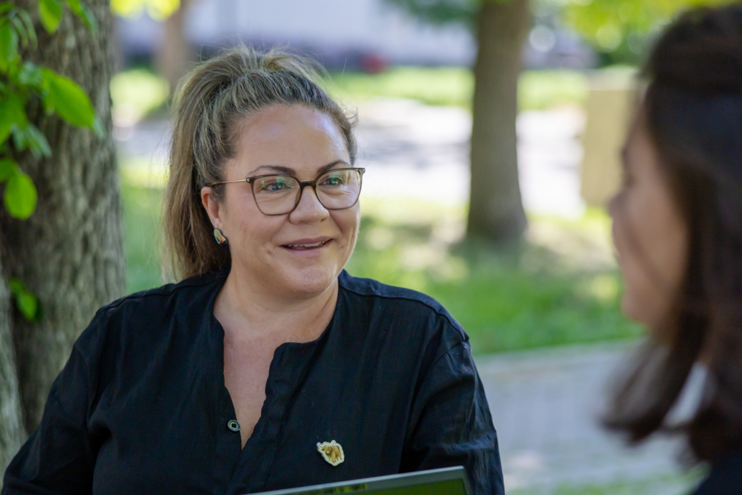 A person smiling outdoors.