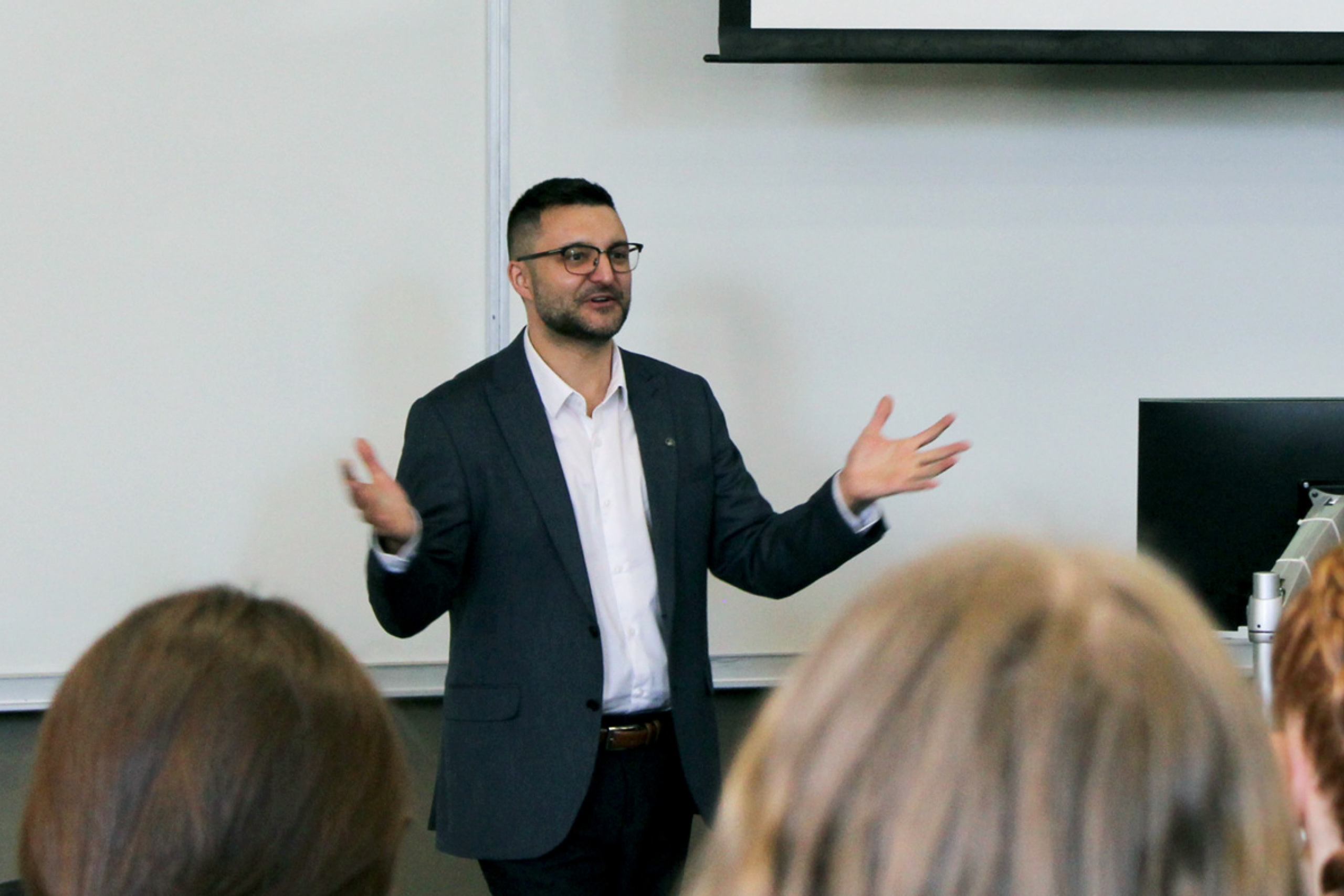 Dr. Rusty Souleymanov giving a presentation to a class