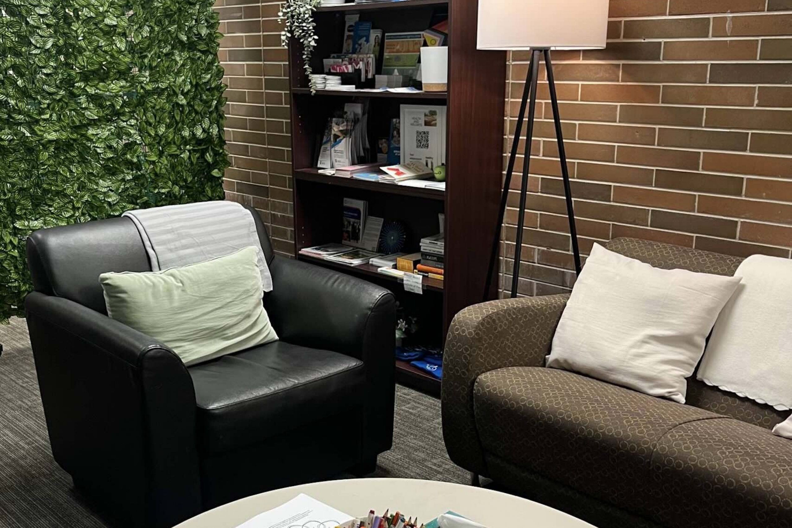 Corner with armchair and sofa and low table.