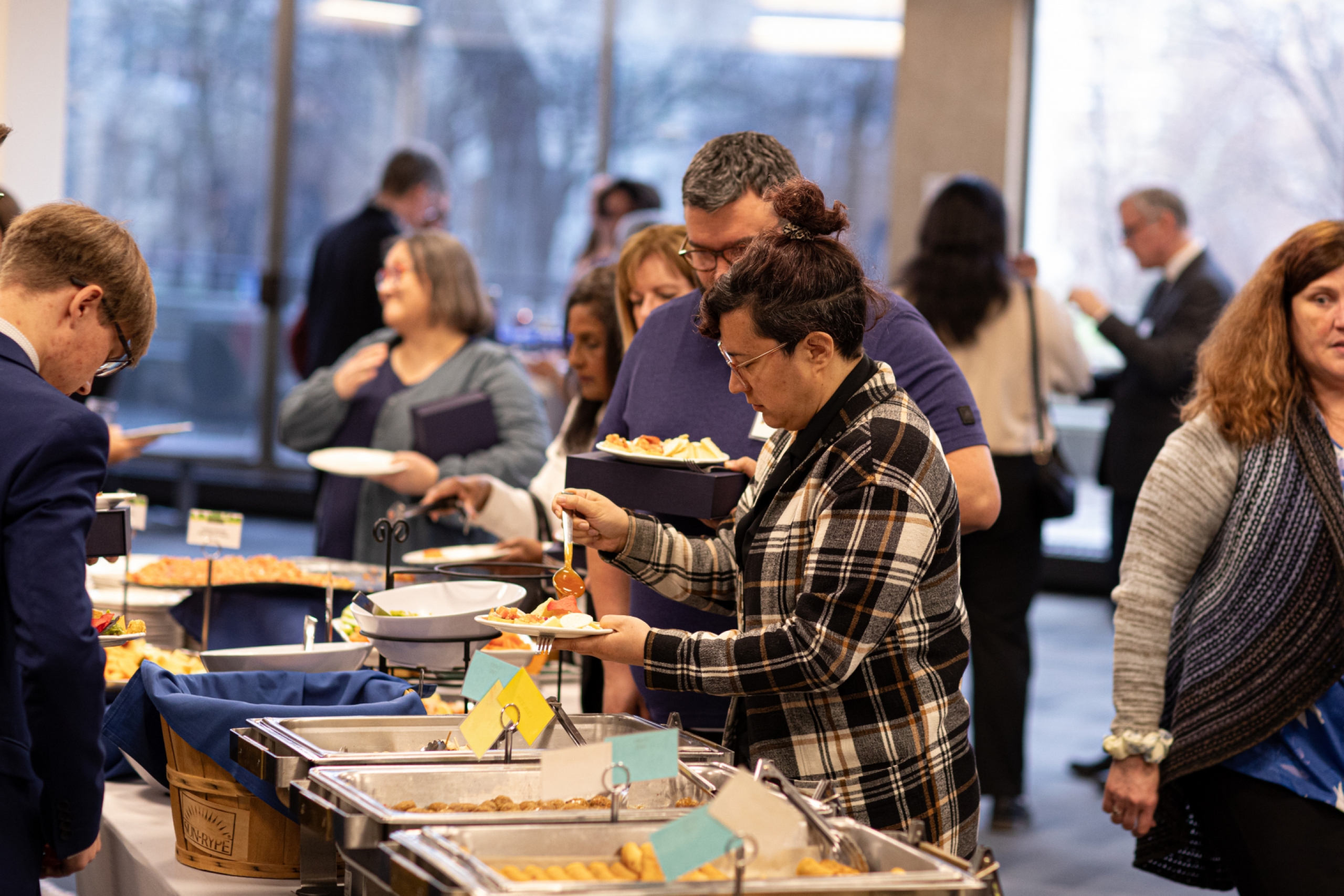 Attendees taking food from a buffet