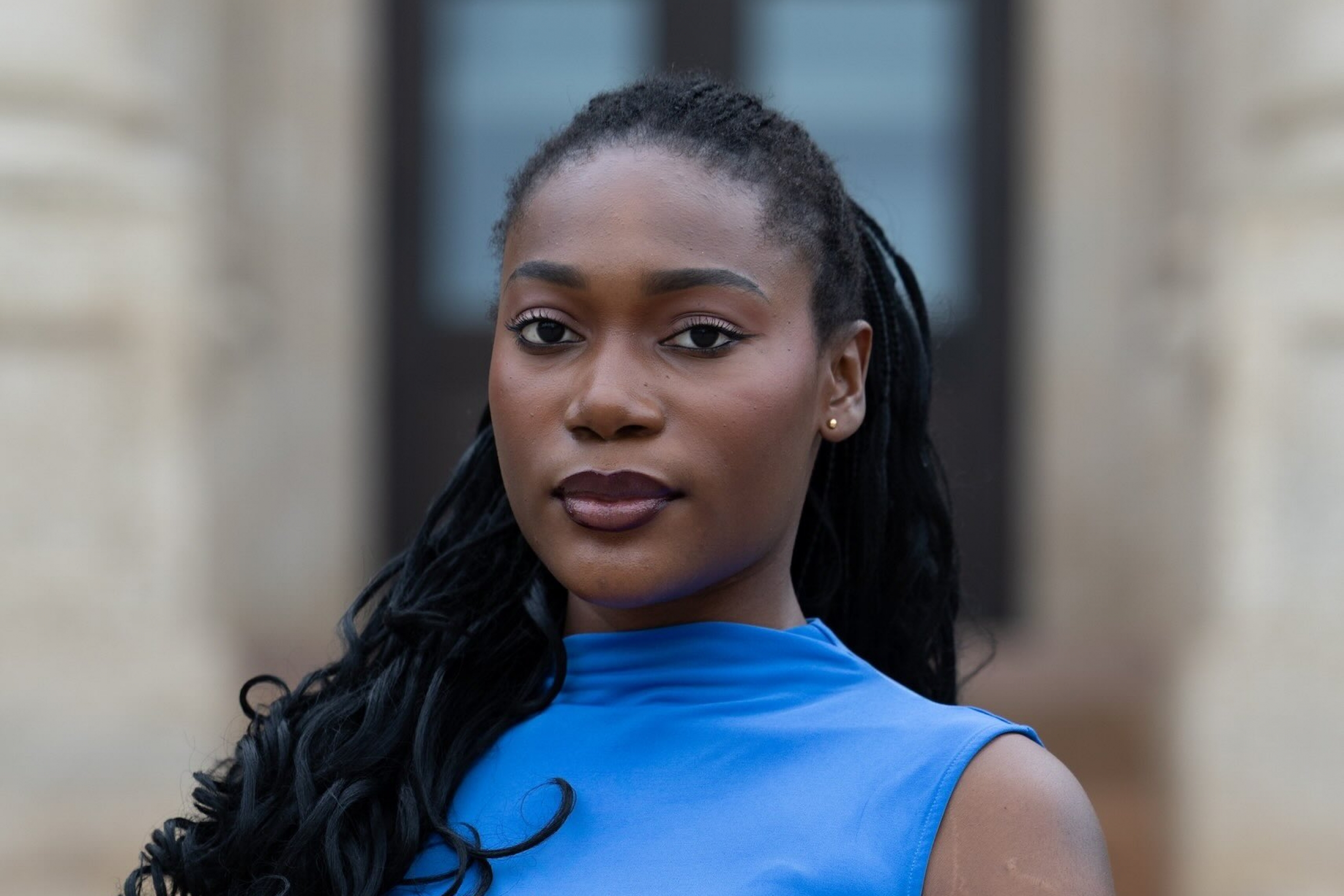 Young Black woman in blue top.