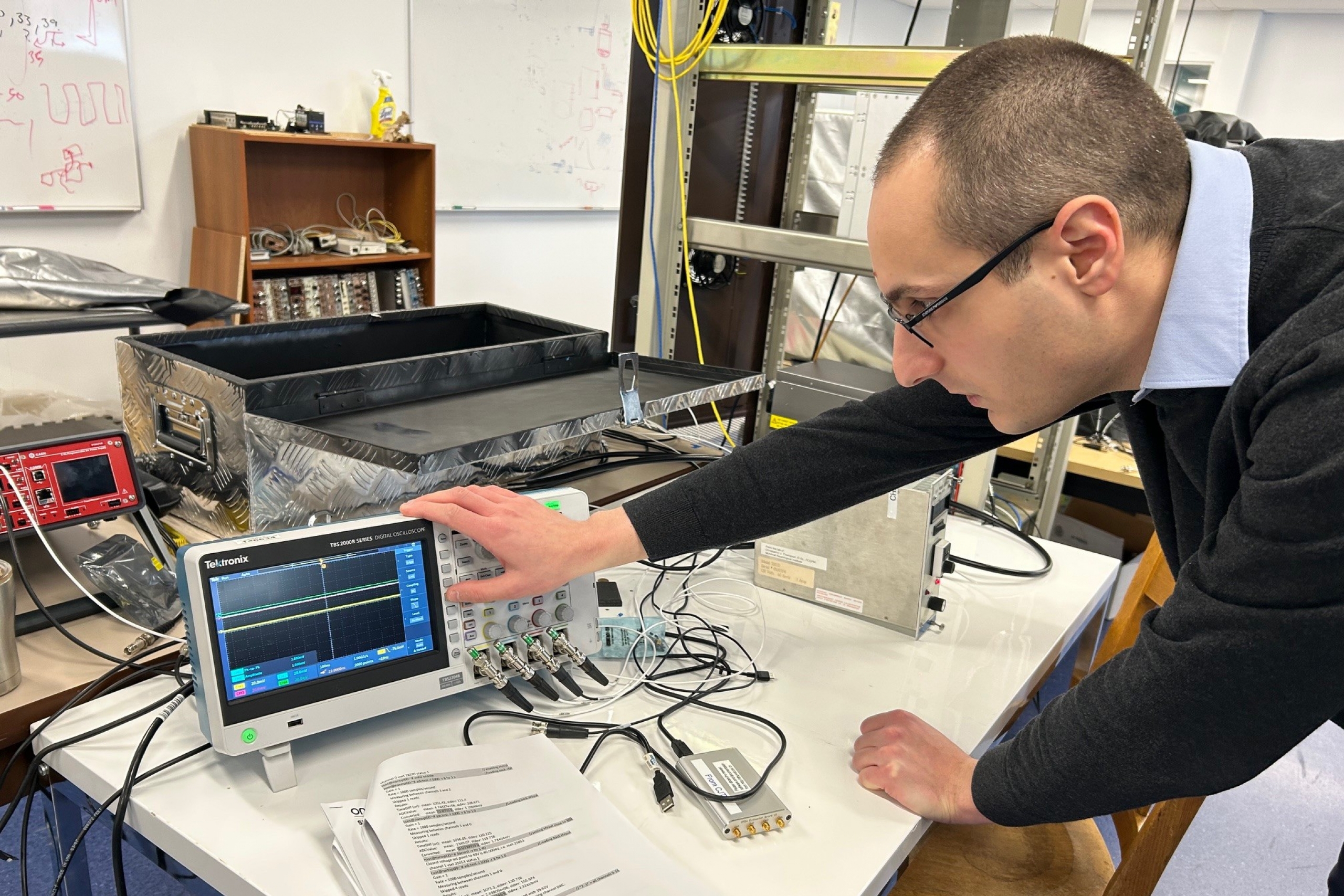 Man operates electronics.