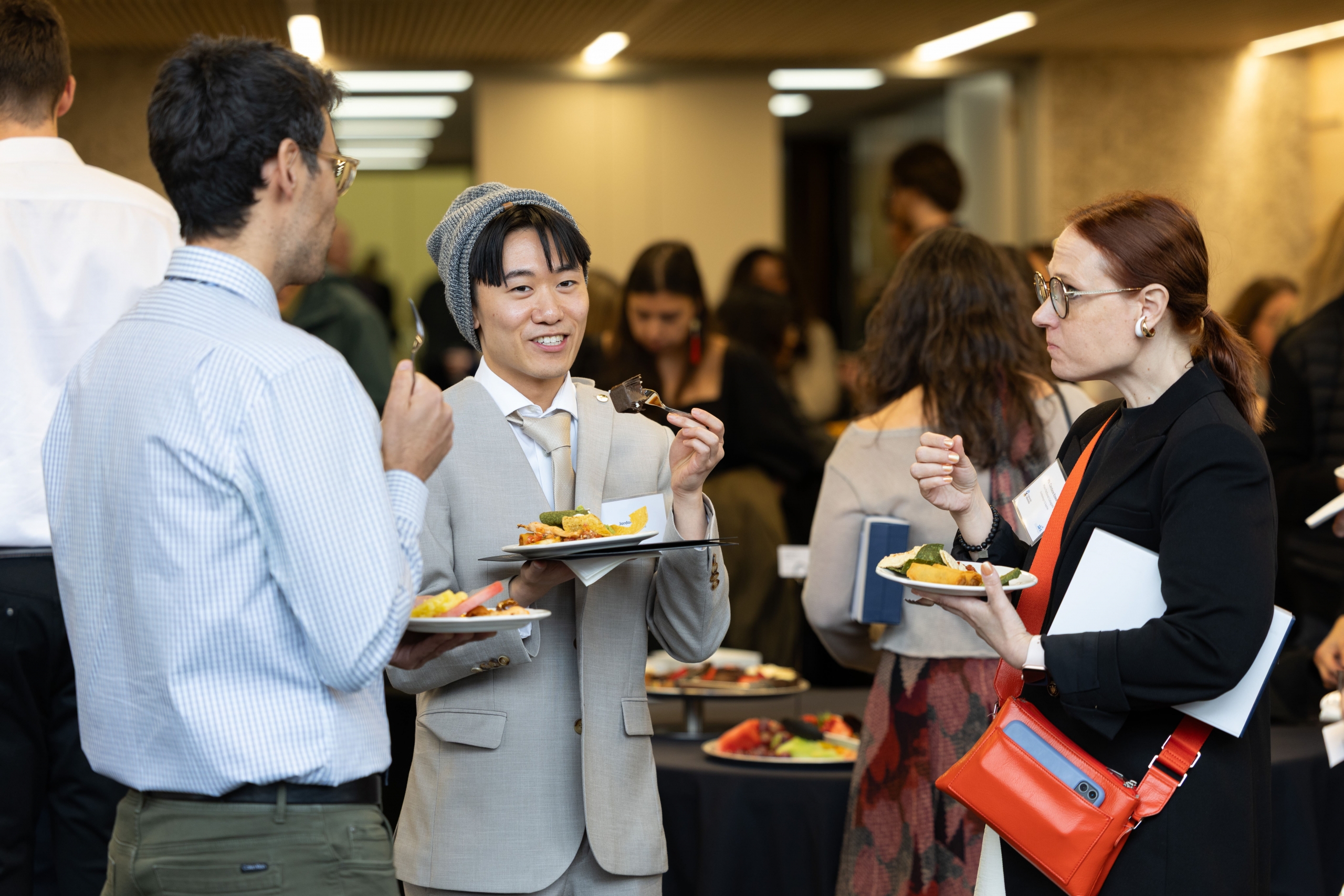 Jordon Hong enjoys a plate of refreshments with other attendees at the end of the reception.