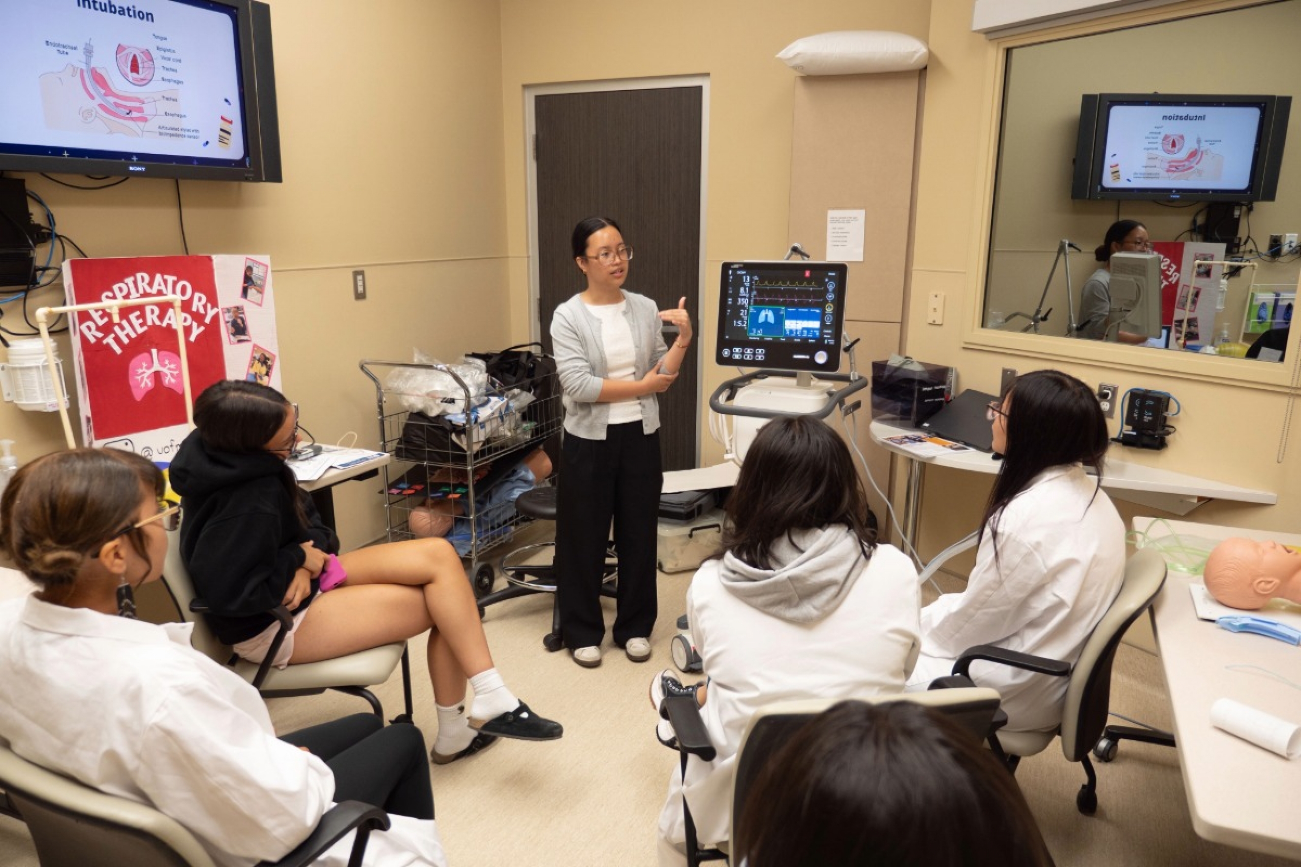 Students in a room listening to a respiratory therapy educator.