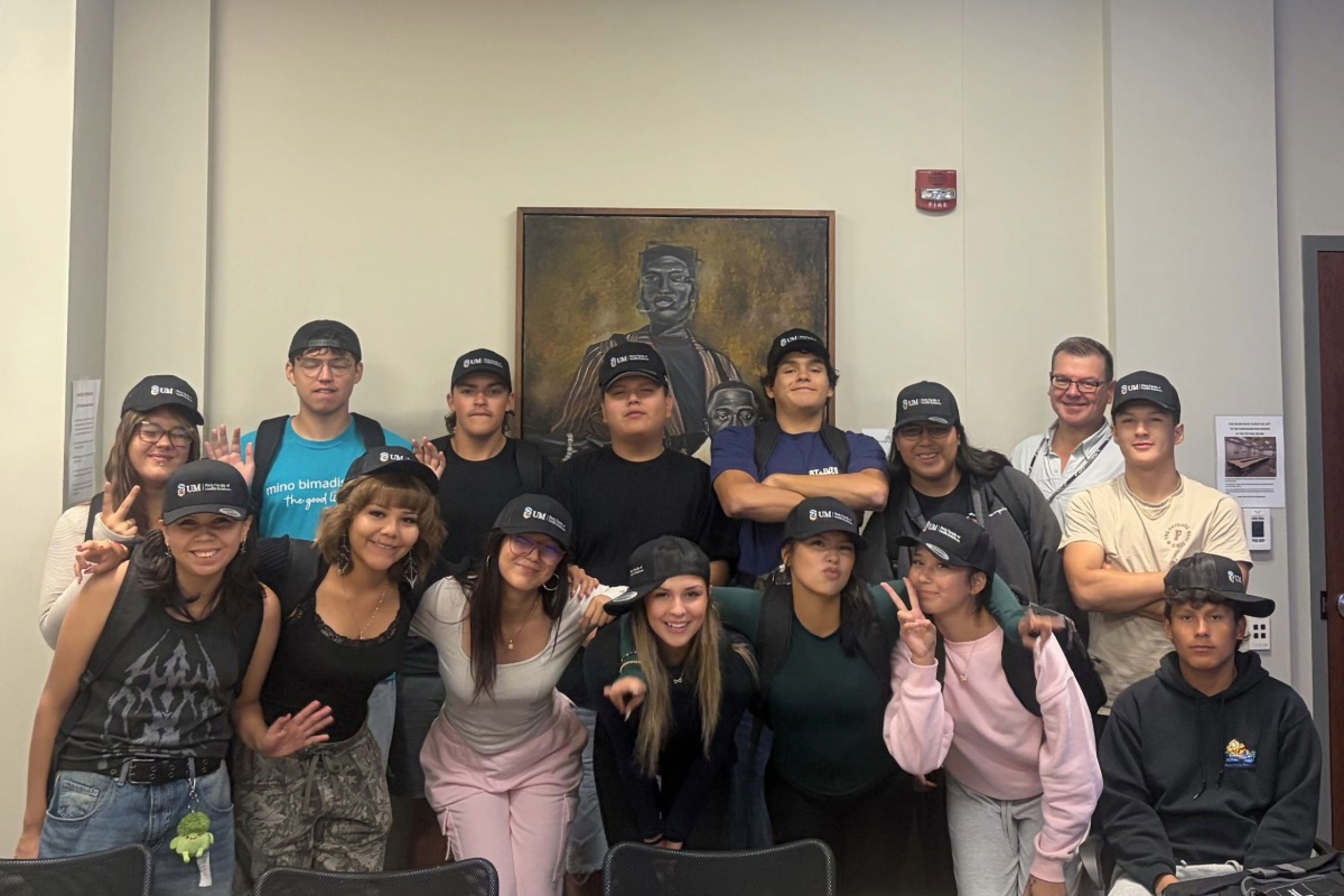 A group of students wearing Rady Faculty of Health Sciences hats pose for a photo.