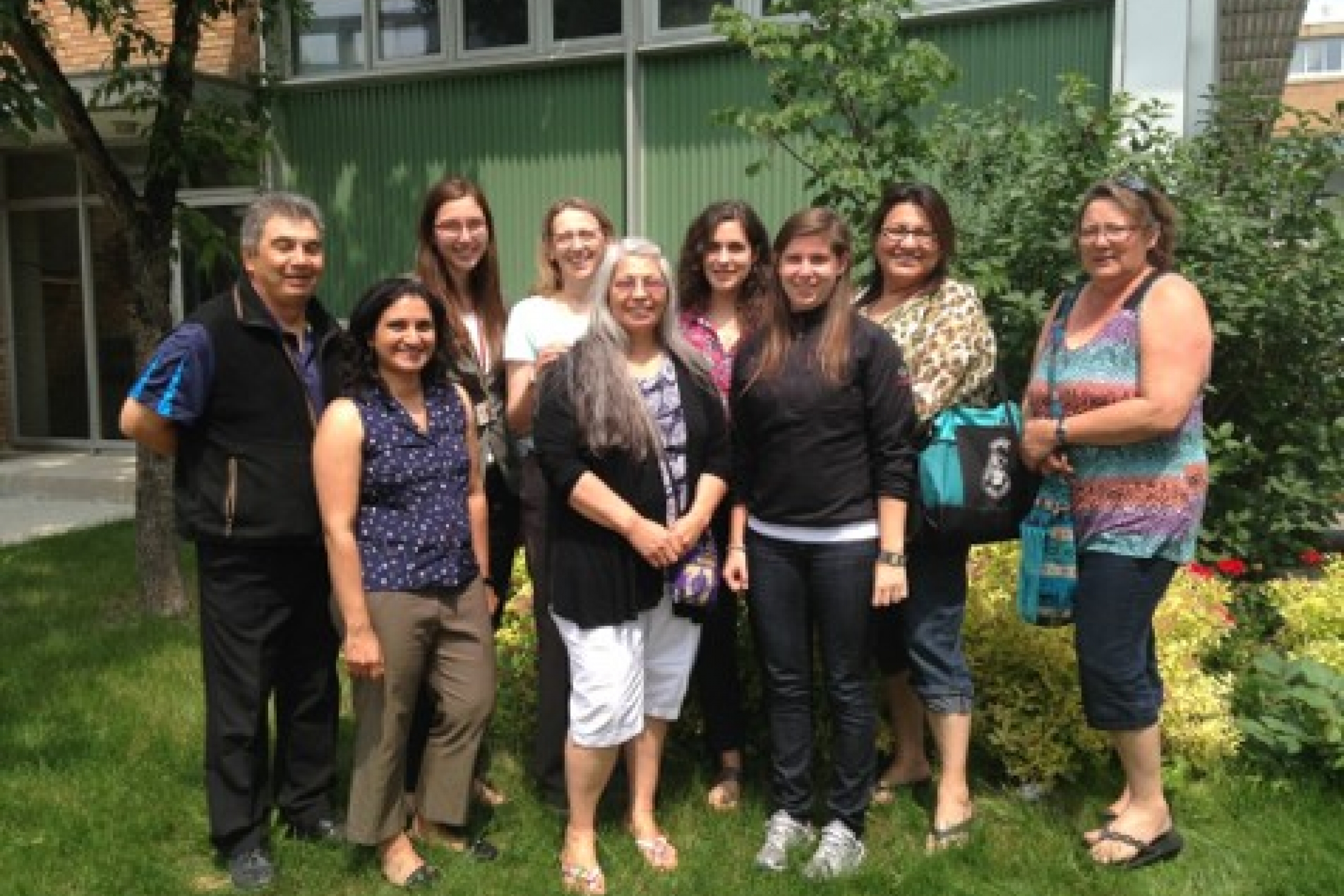 Outdoor group photo with nine people.