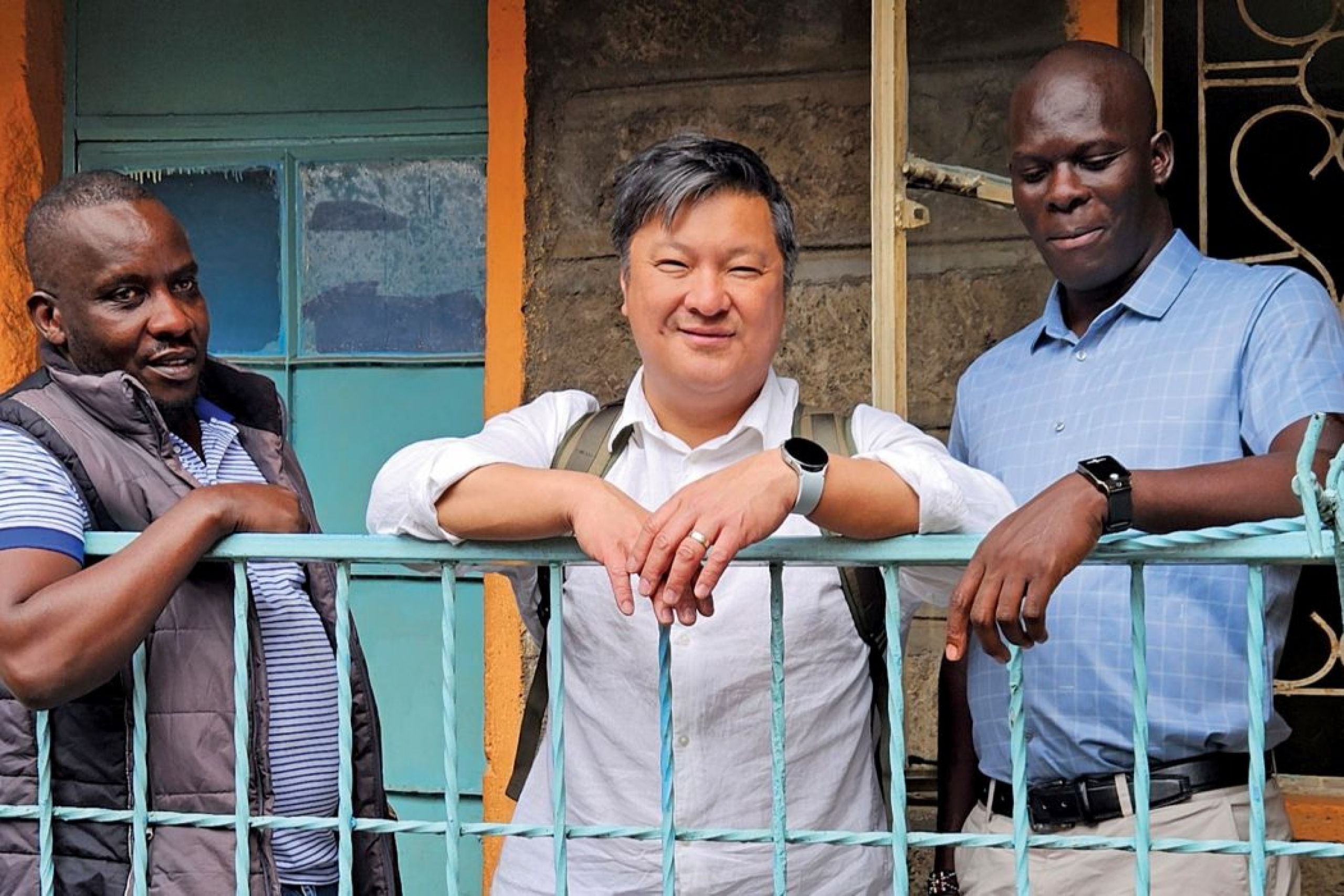 Three people smile at the camera.