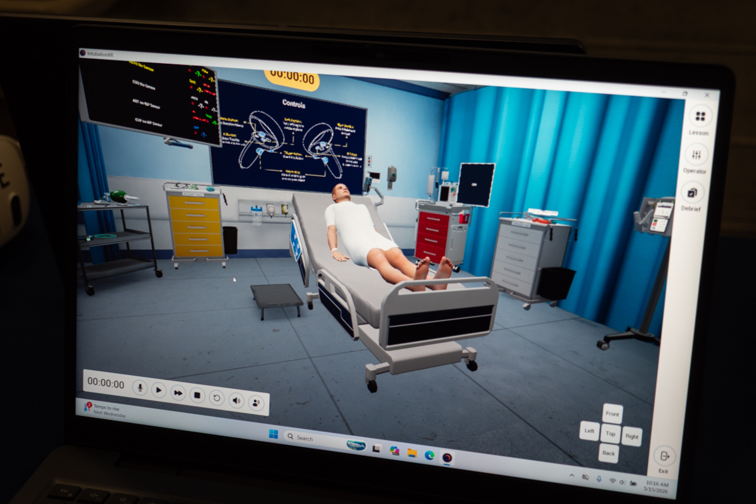 Laptop screen with a VR scene in a hospital room.