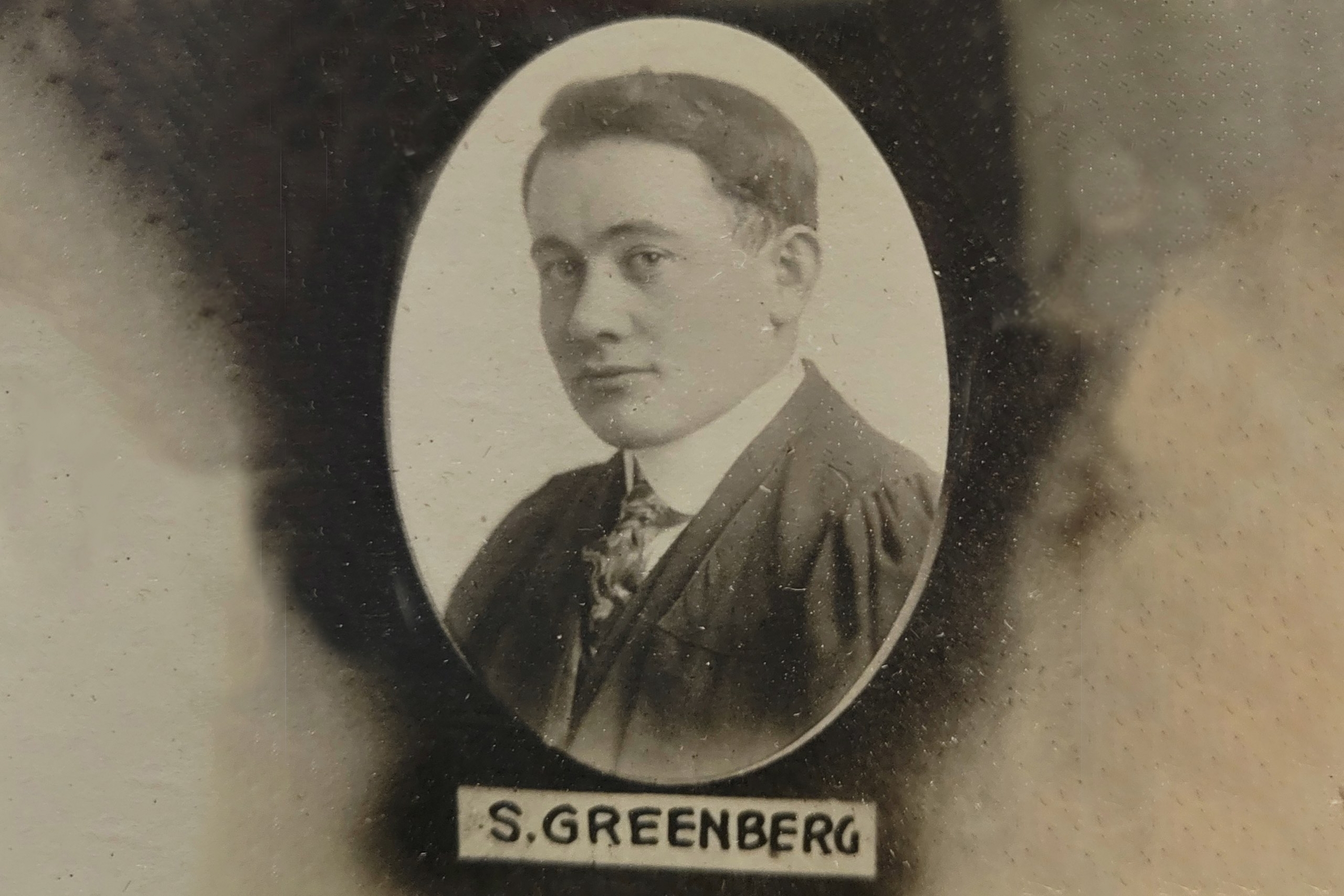 an old fashioned oval portrait of a young man from 1918 marked S Greenberg