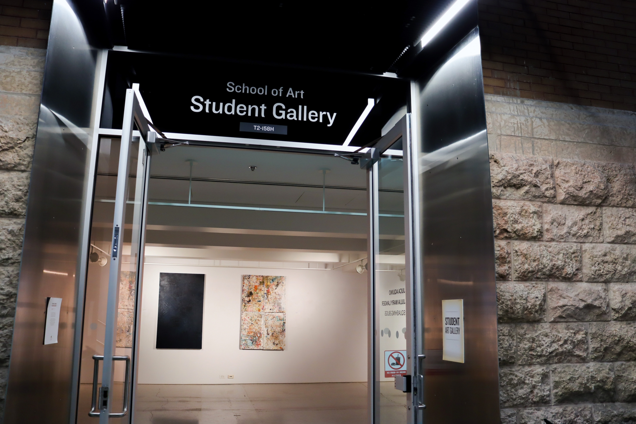 Entrance to the School of Art Student Gallery with open doors revealing exhibition works inside.