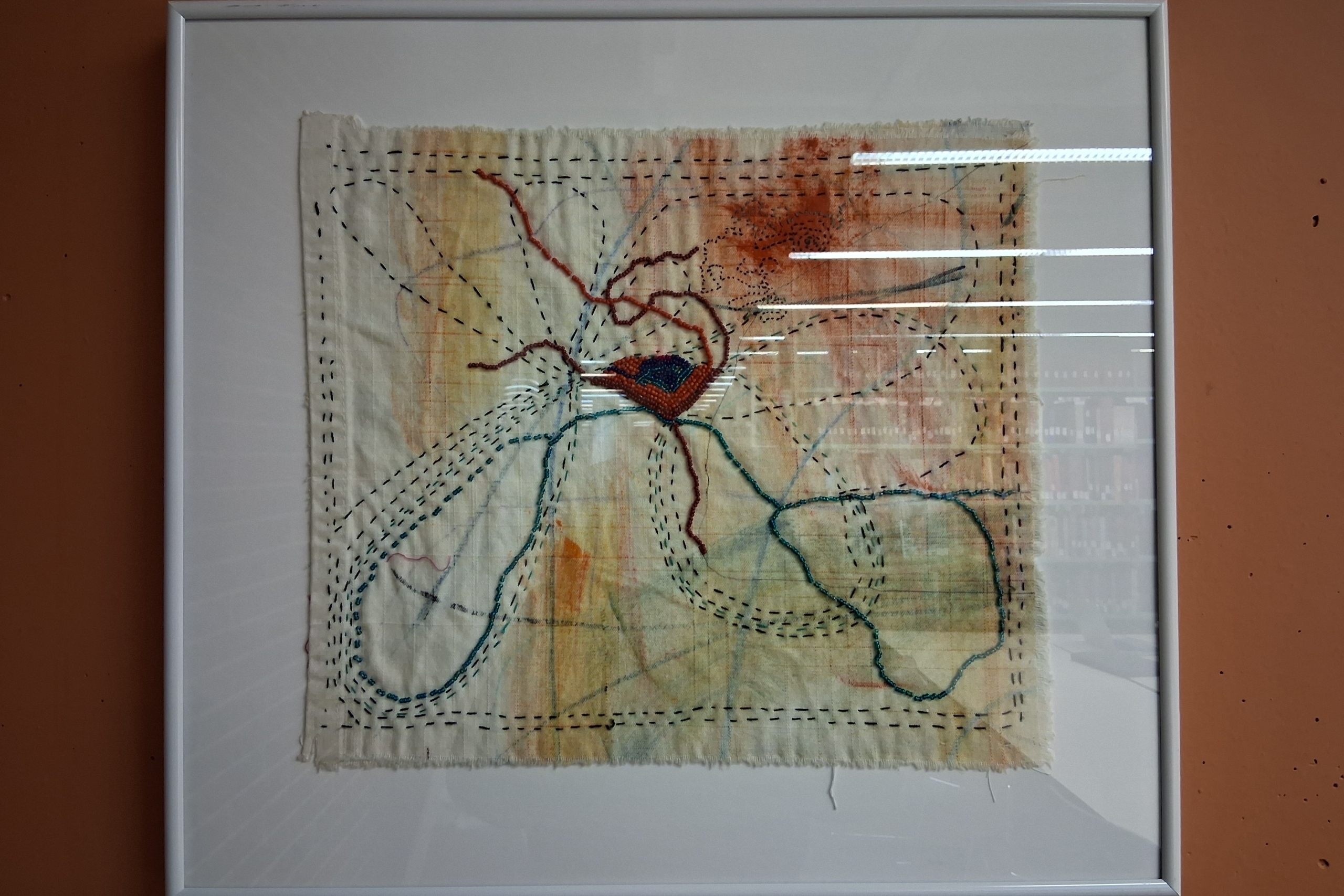 Framed embroidery art that looks like rivers and veins