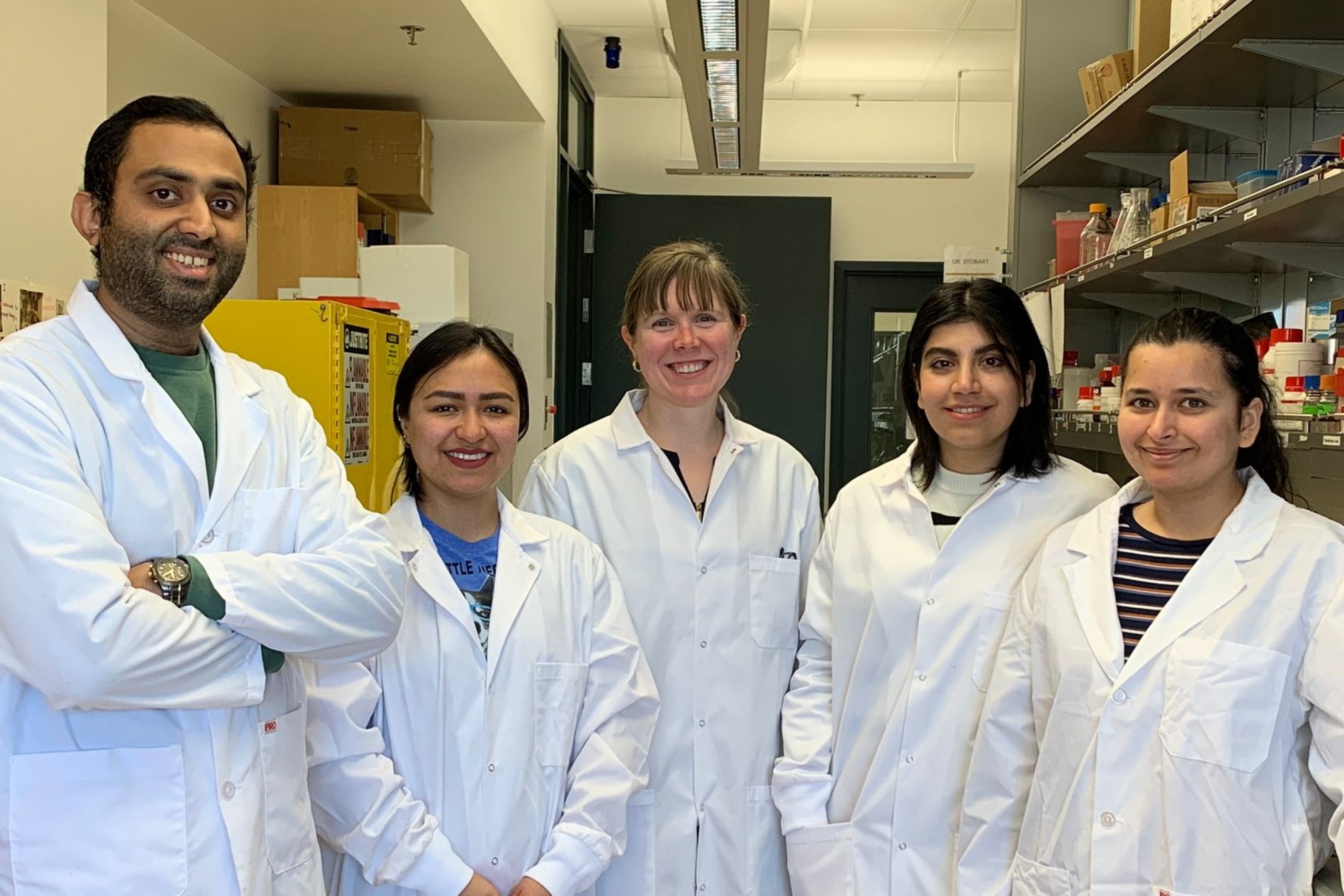 A group of scientists in white lab coats.