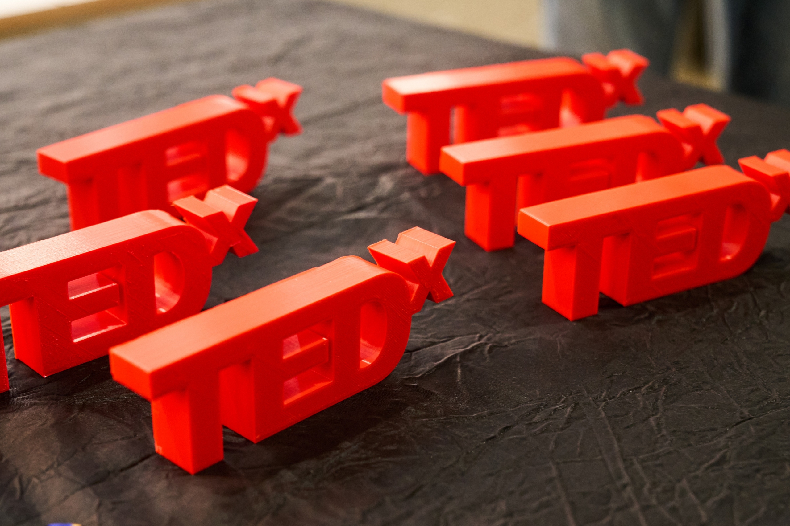 3D printed TEDx trinkets lined up on a table
