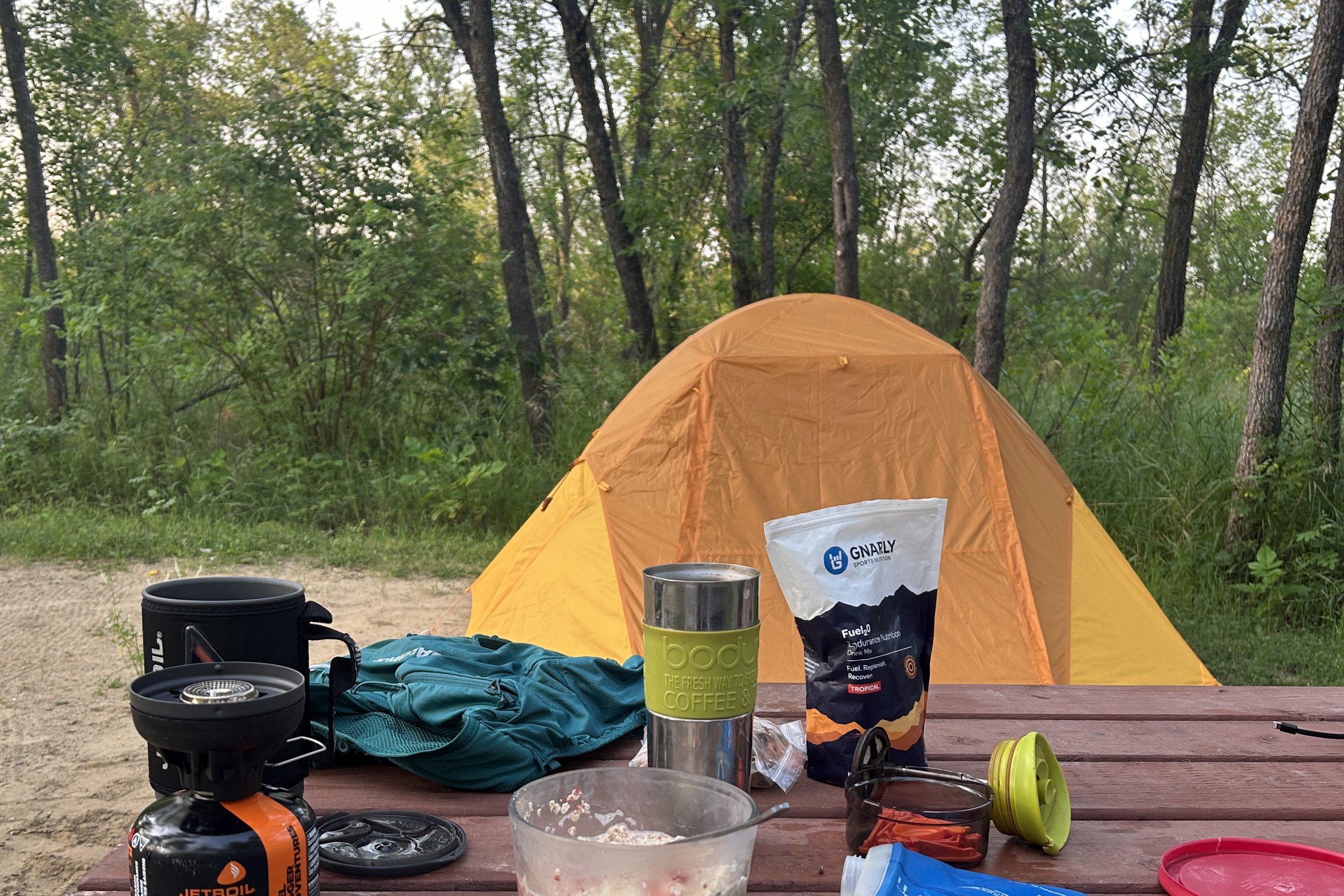 Orange tent and a picnic table