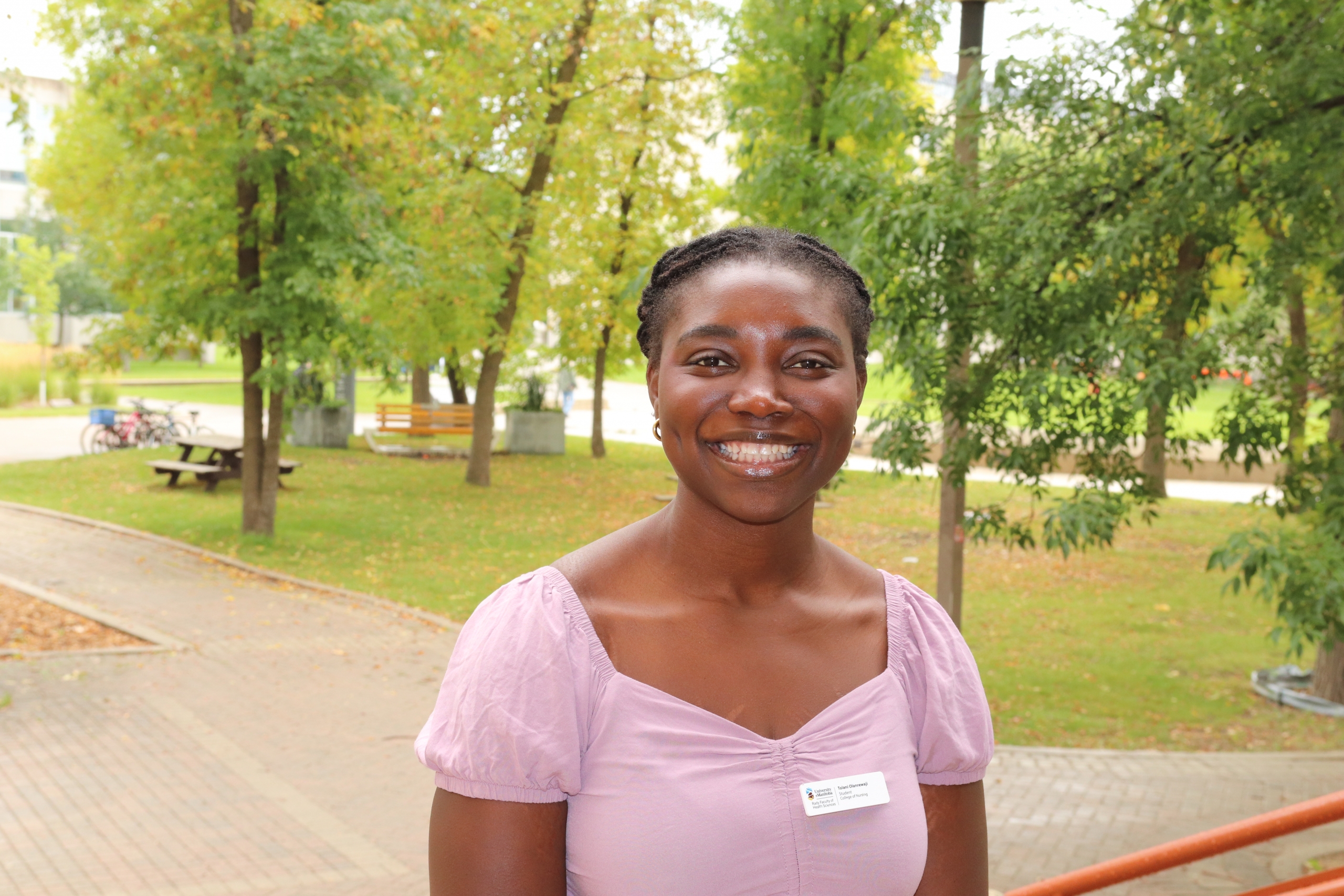 Tolani Olanrewaju standing outside at the Fort Garry campus.