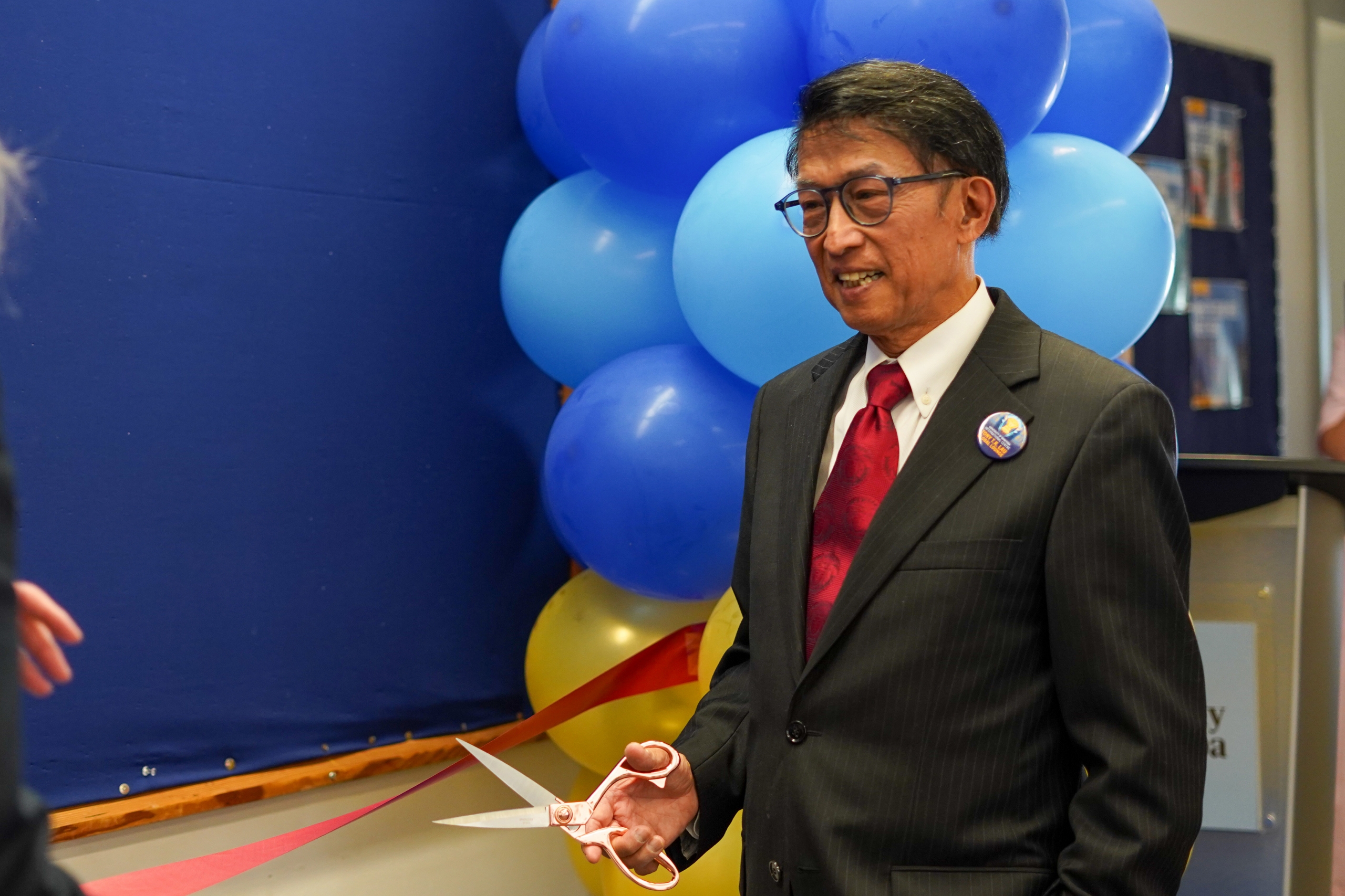 Tony Lau cutting the ribbon to open the new international students' centre