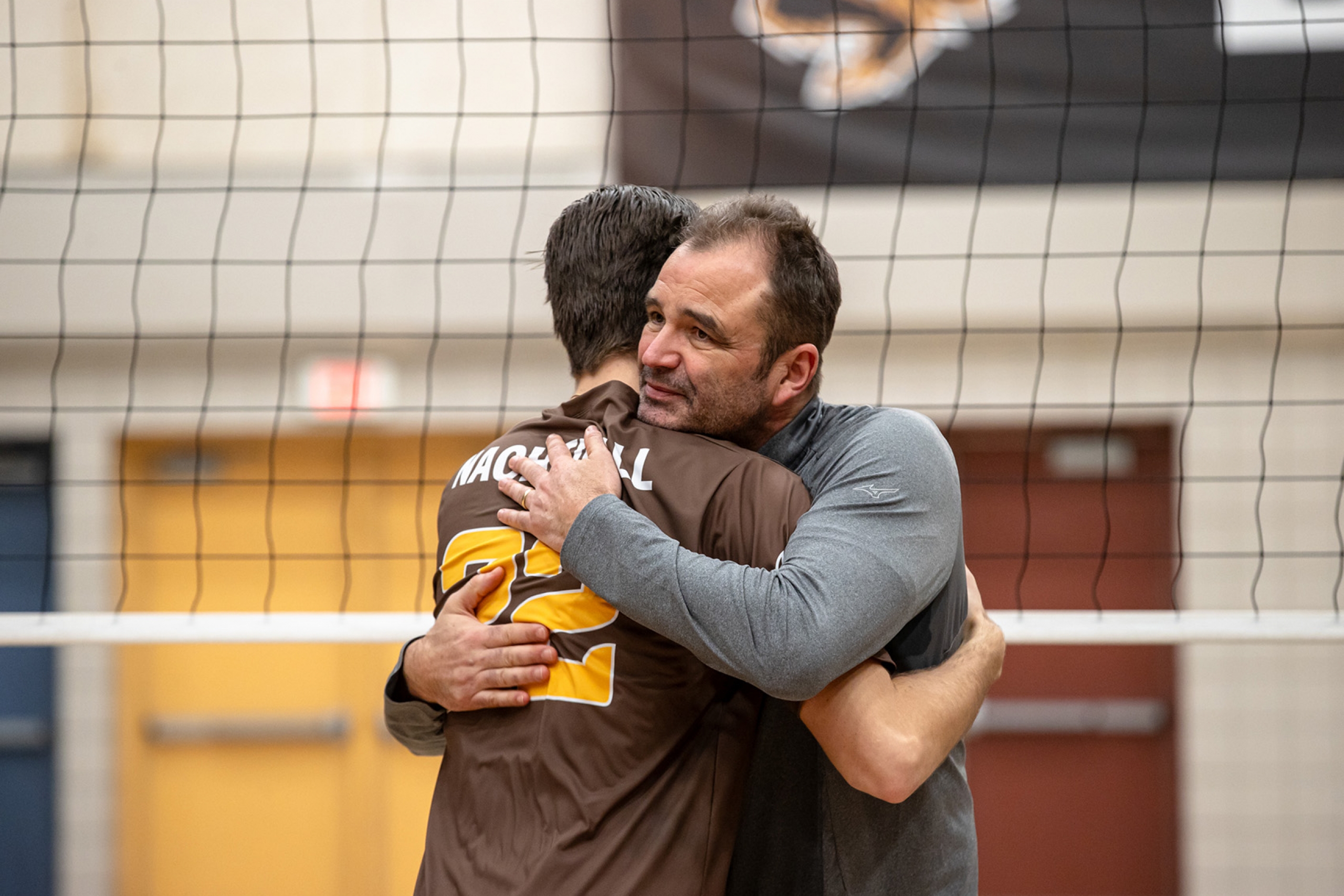 Tyson Nachtigall and head coach Lupo Ludwig hugging