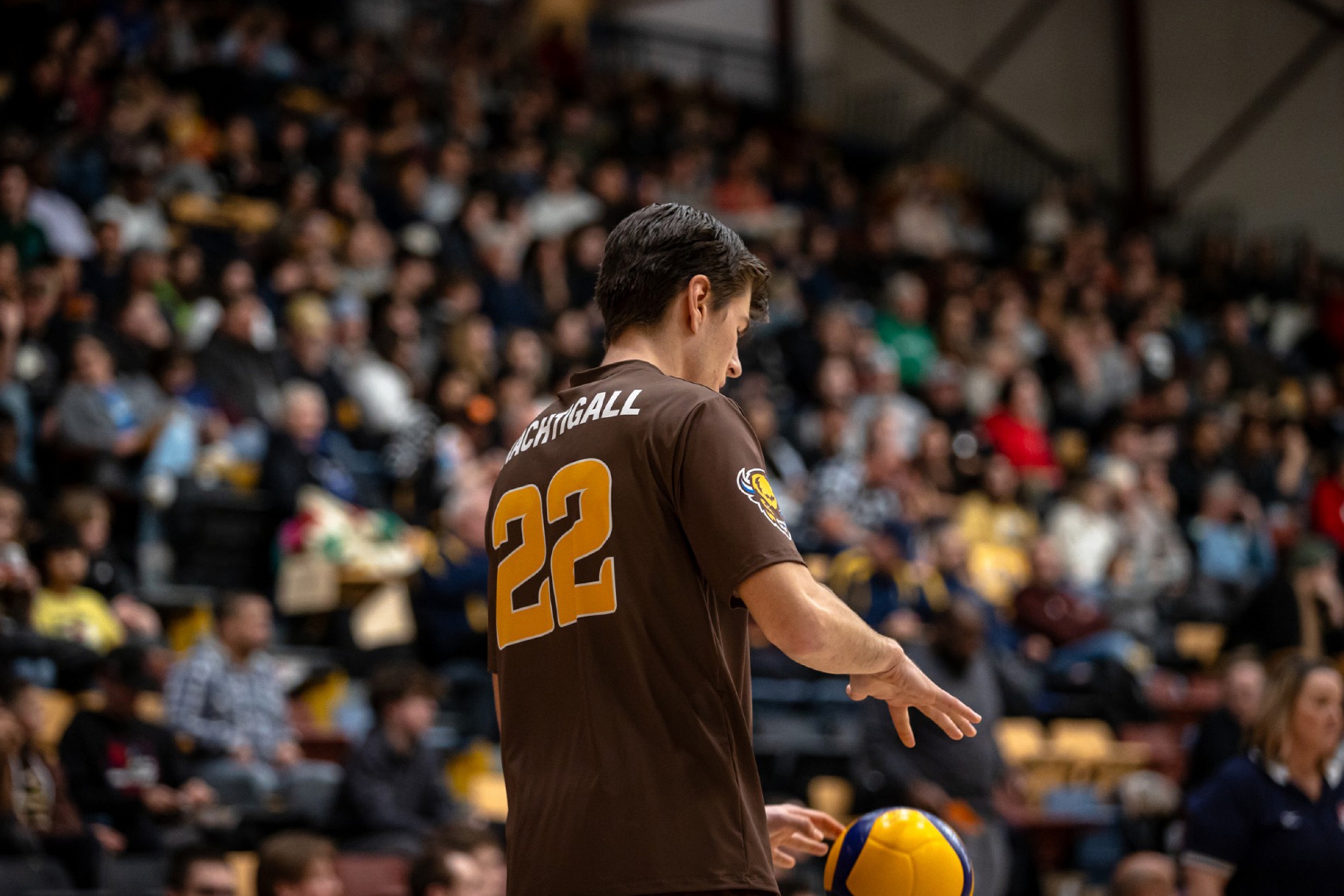 Tyson Nachtigall preparing to serve in front of a large crowd
