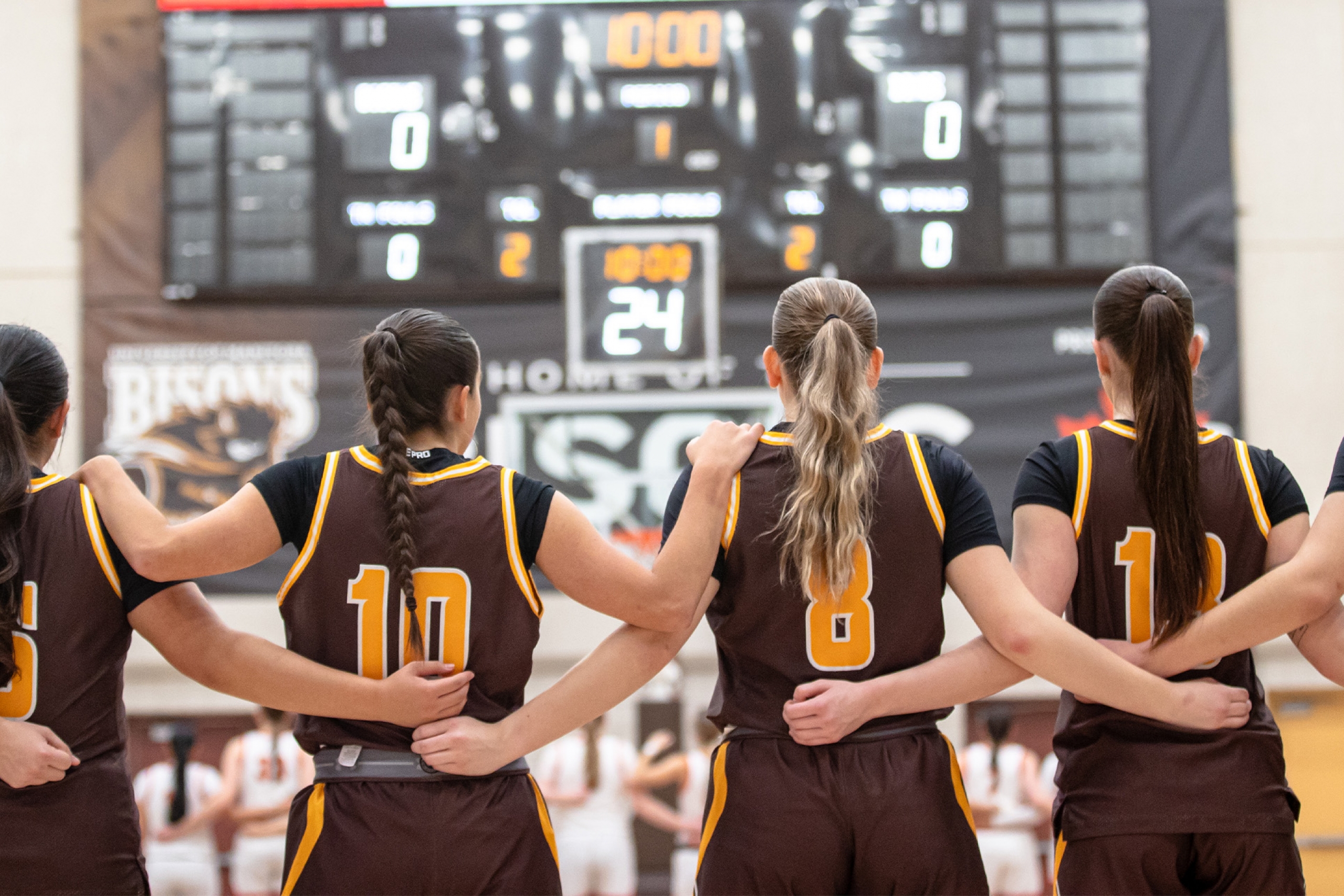 The Bisons women's basketball team stand together during O Canada before a game in the 2025-2026 season.