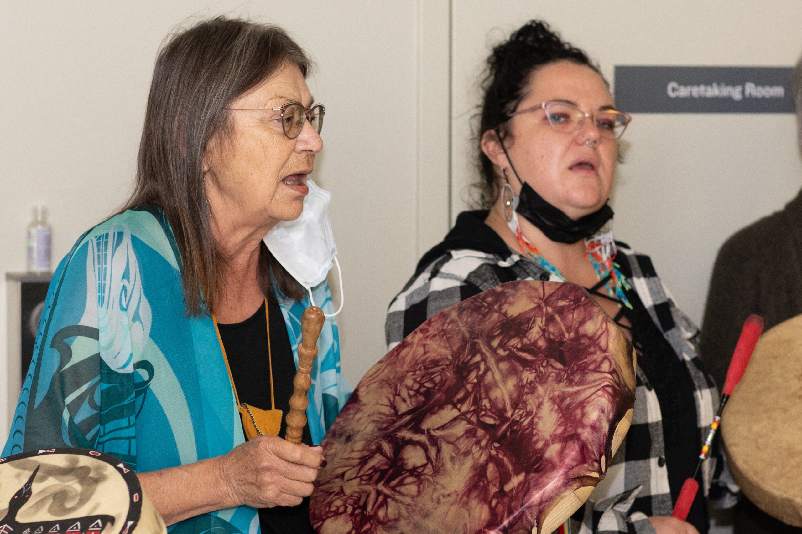 Indigenous women drumming and singing