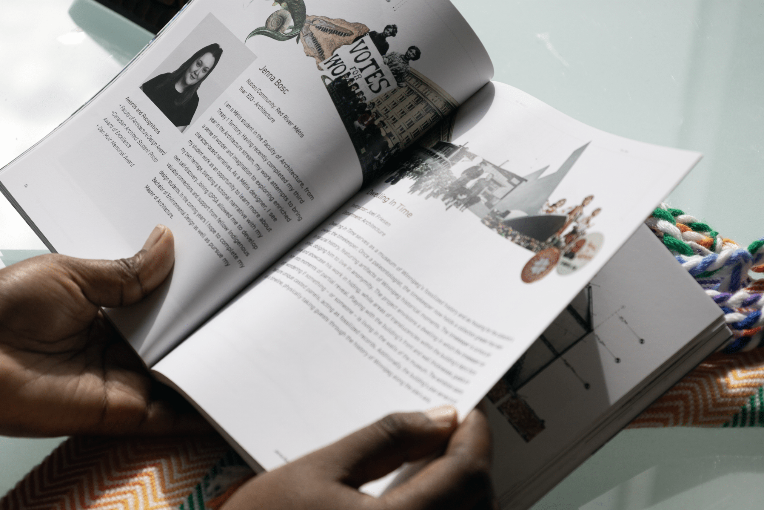 Hands hold an open illustrated book with portraits, text, and collage art, resting on a colorful woven textile; an informative, reflective scene. Photo by Ayla Simone
