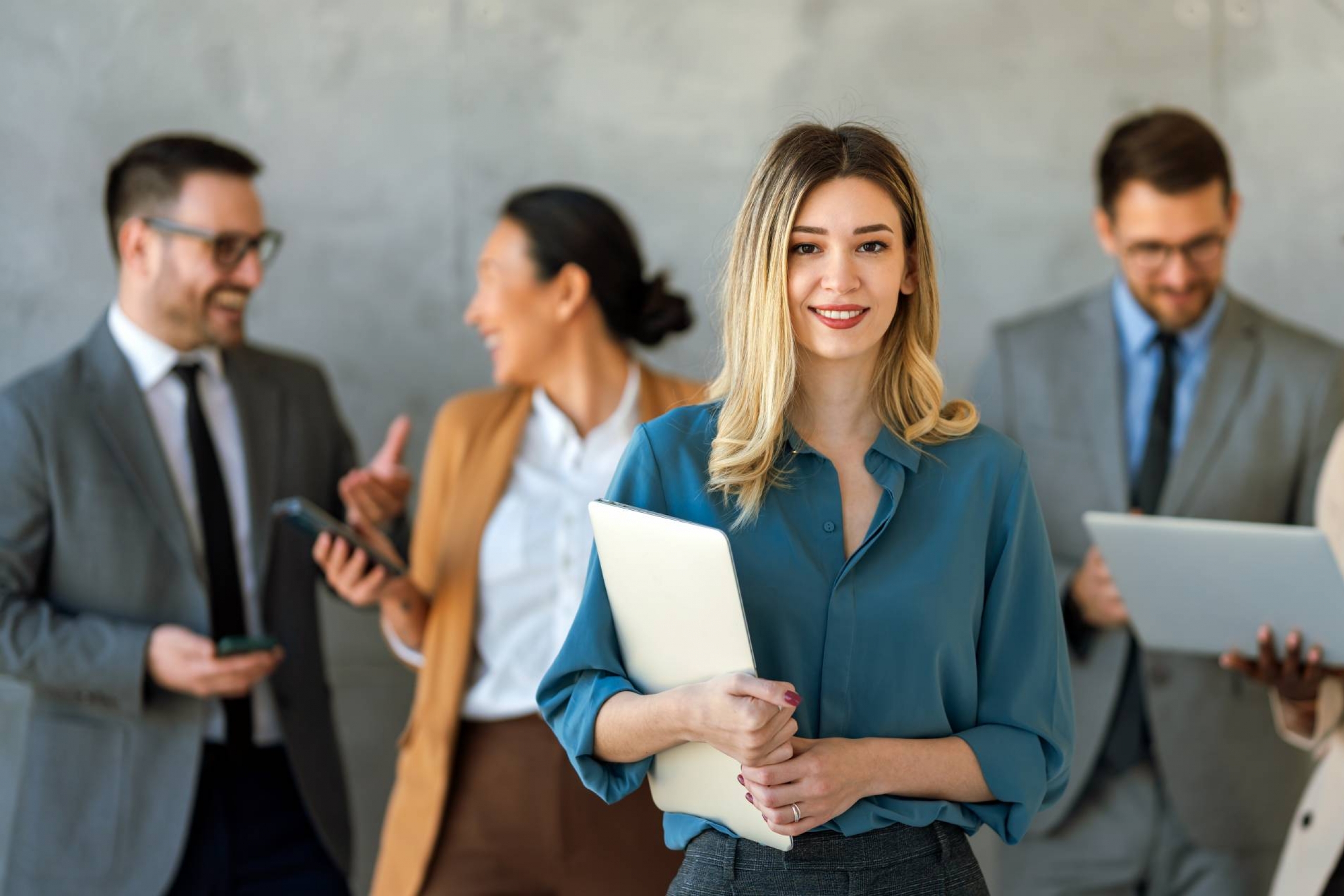 woman surrounded by work colleagues smiles