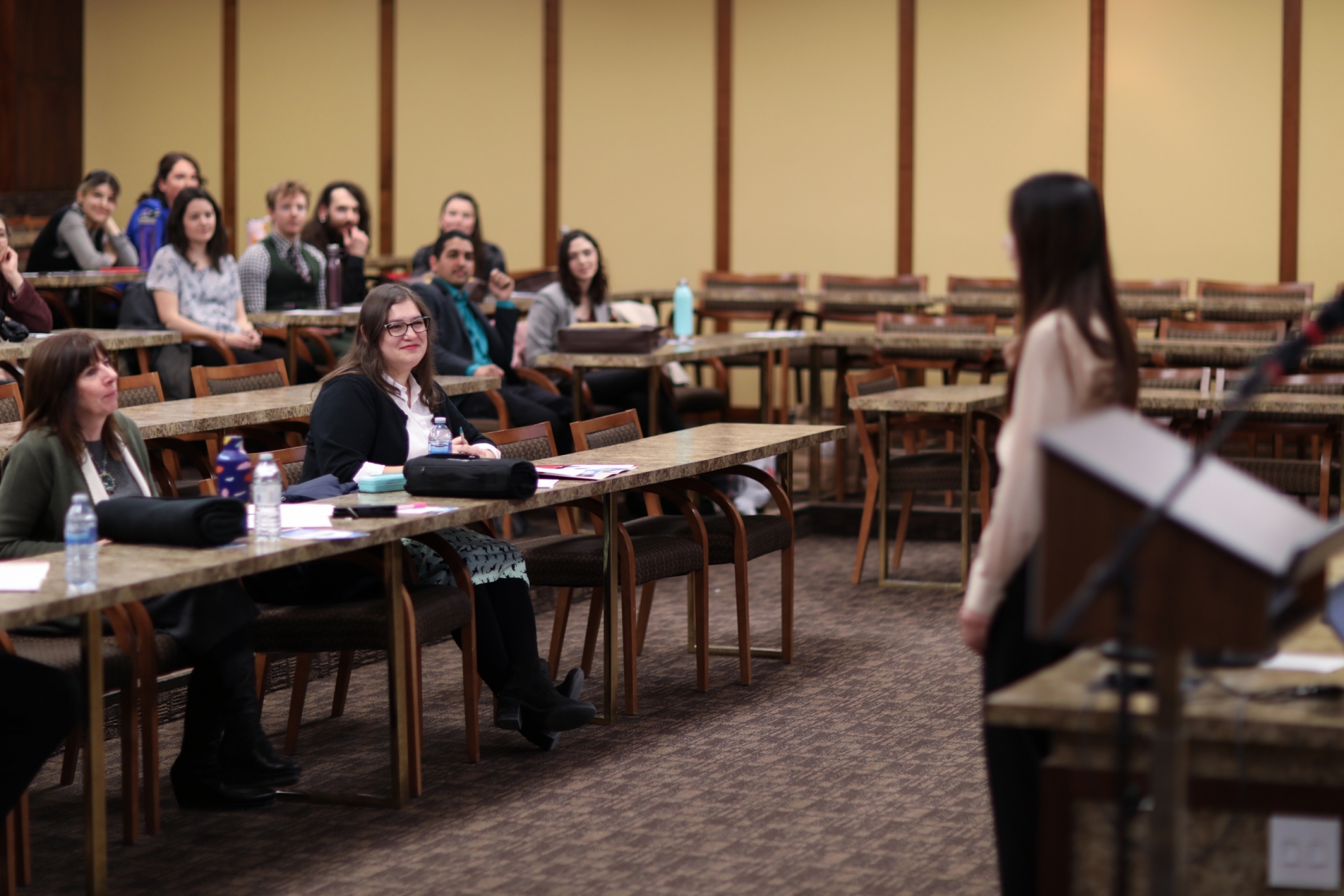 Student presents to a room full of people