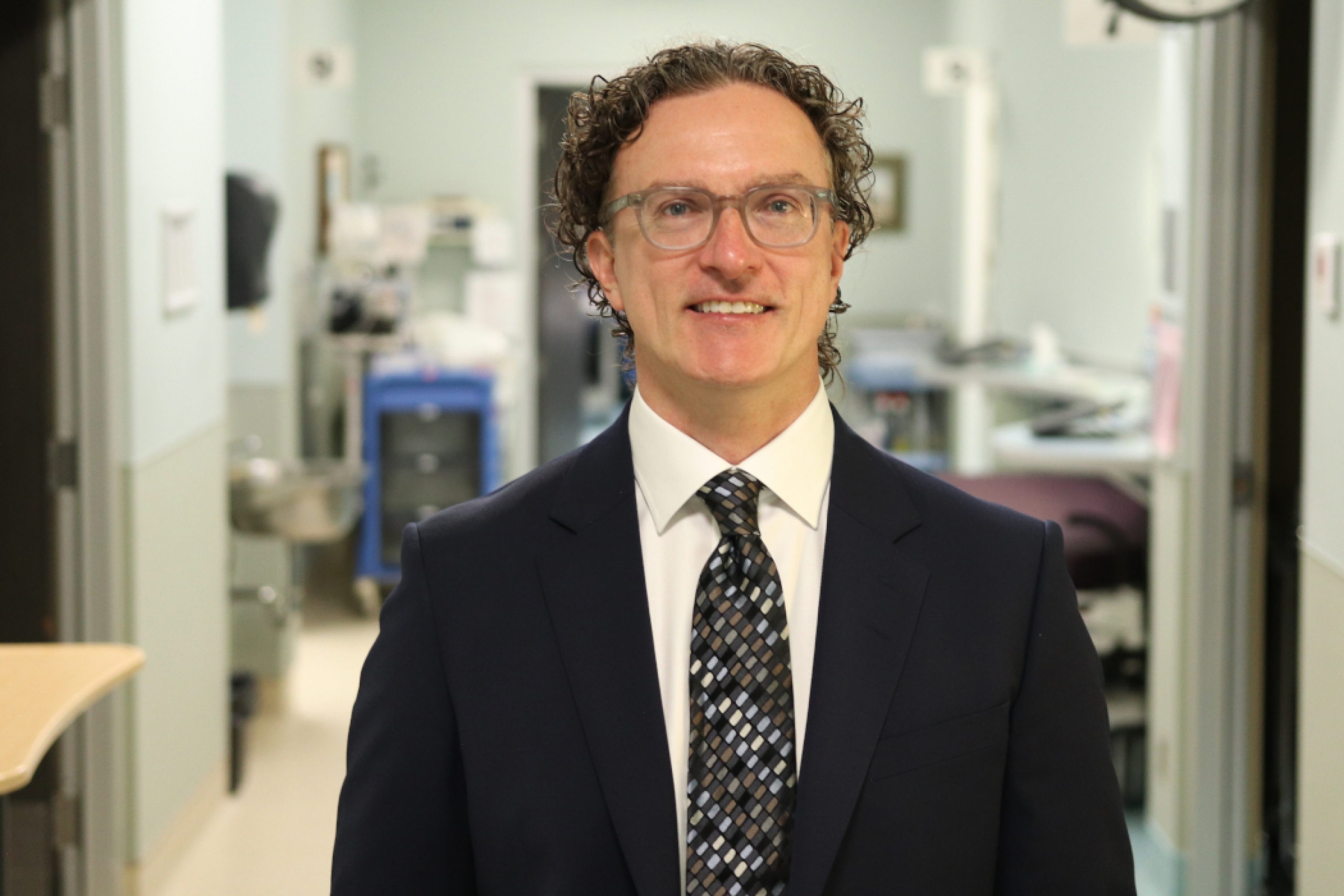A portrait of Dr. Ryan Zarychanski in a clinical setting. 