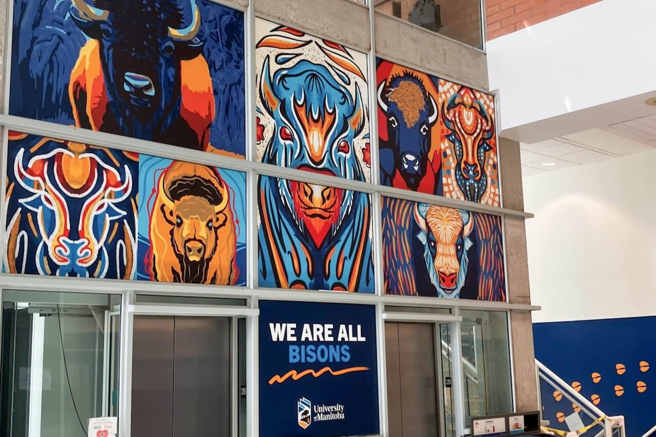 Illustrated bisons are shown applied above elevator doors.