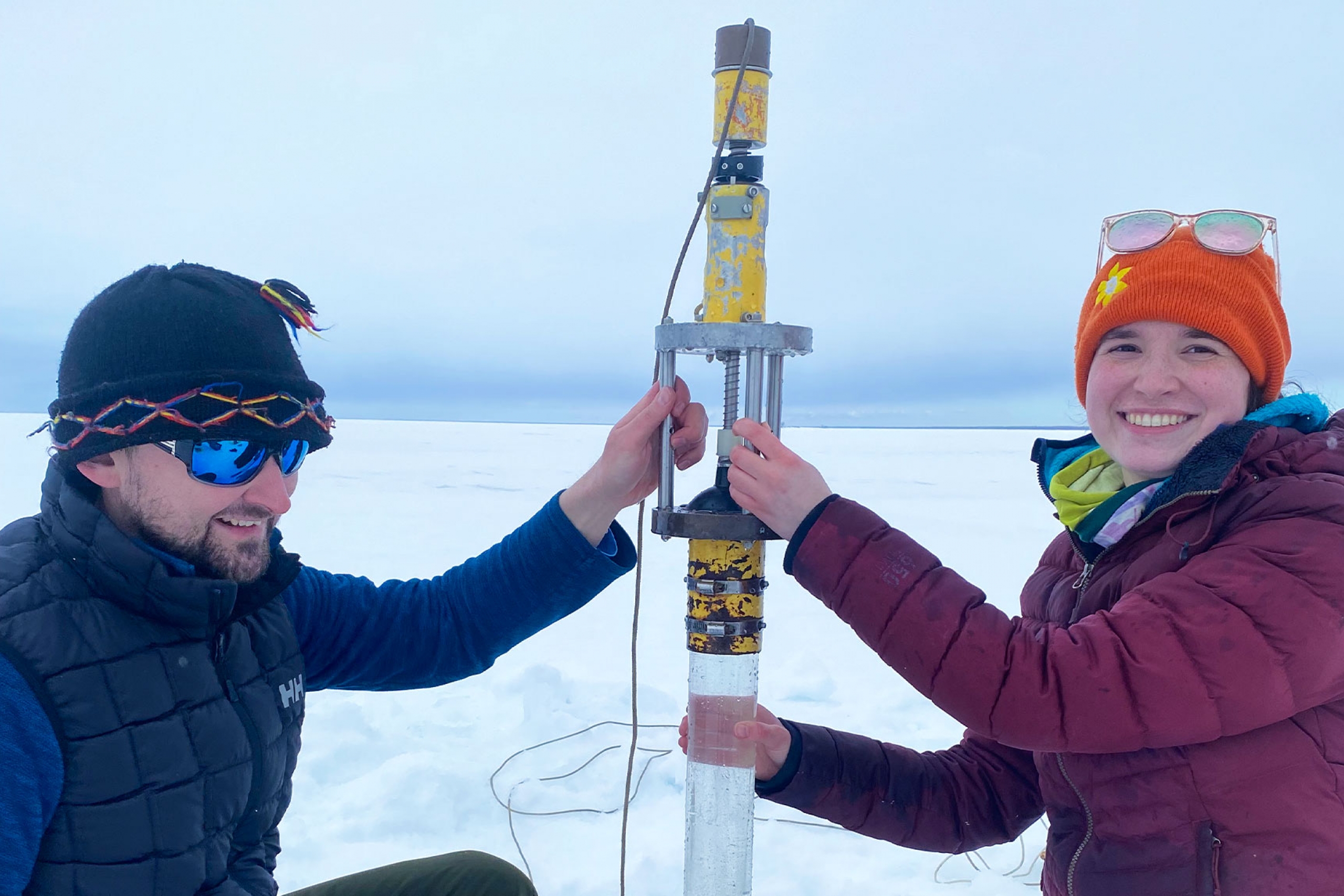 Dr. Cale Gushulak with a student smiling at the camera during their fieldwork.