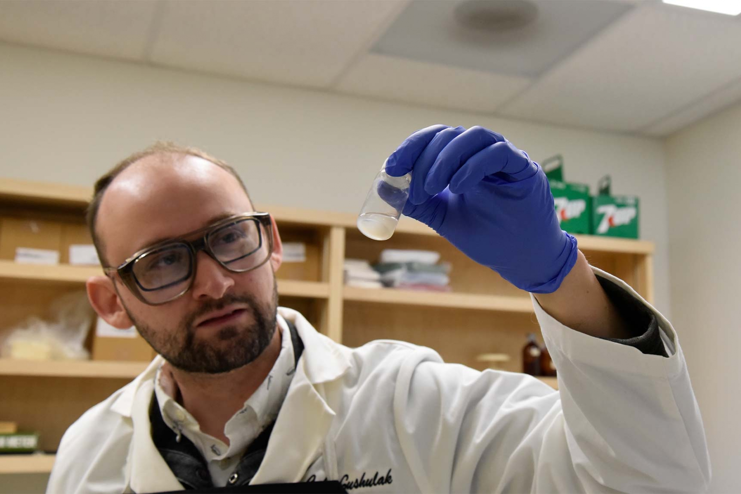 Cale Gushulak looking at a specimen.