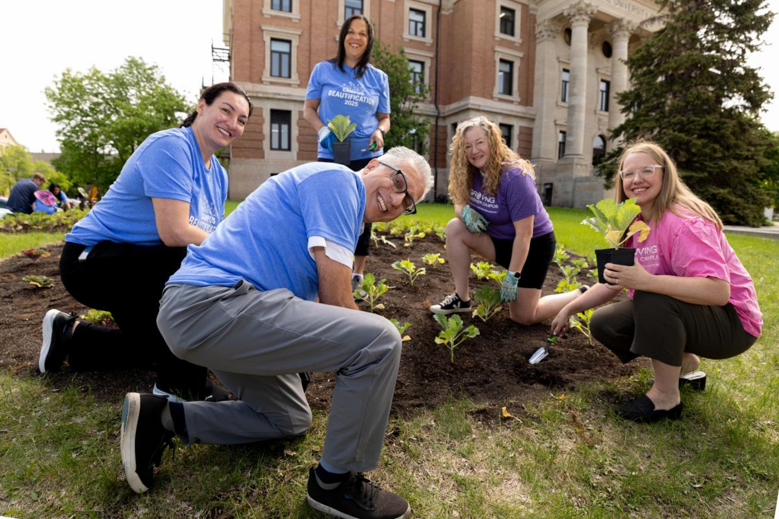 President Benarroch and four other people are planting flowers