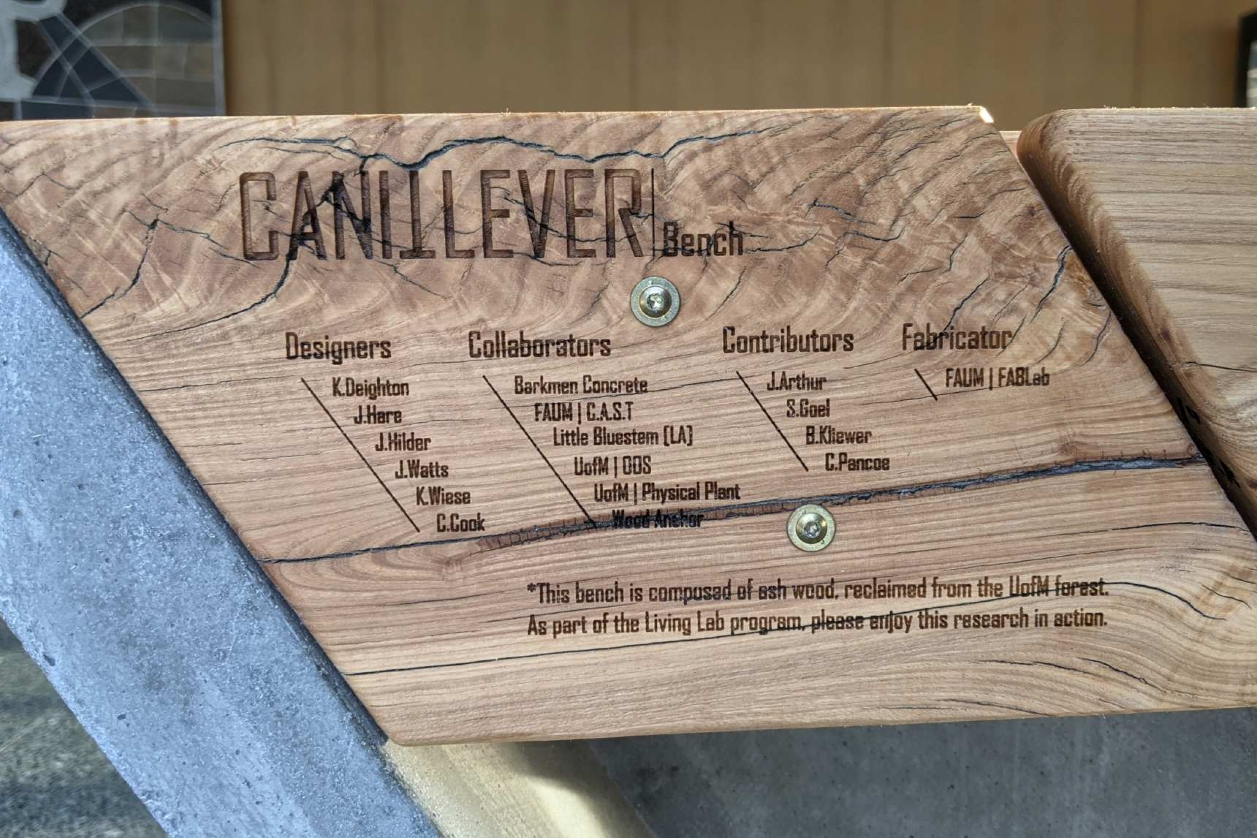 Close-up of the Can-it-Lever mark on the side of a bench made from reclaimed wood.