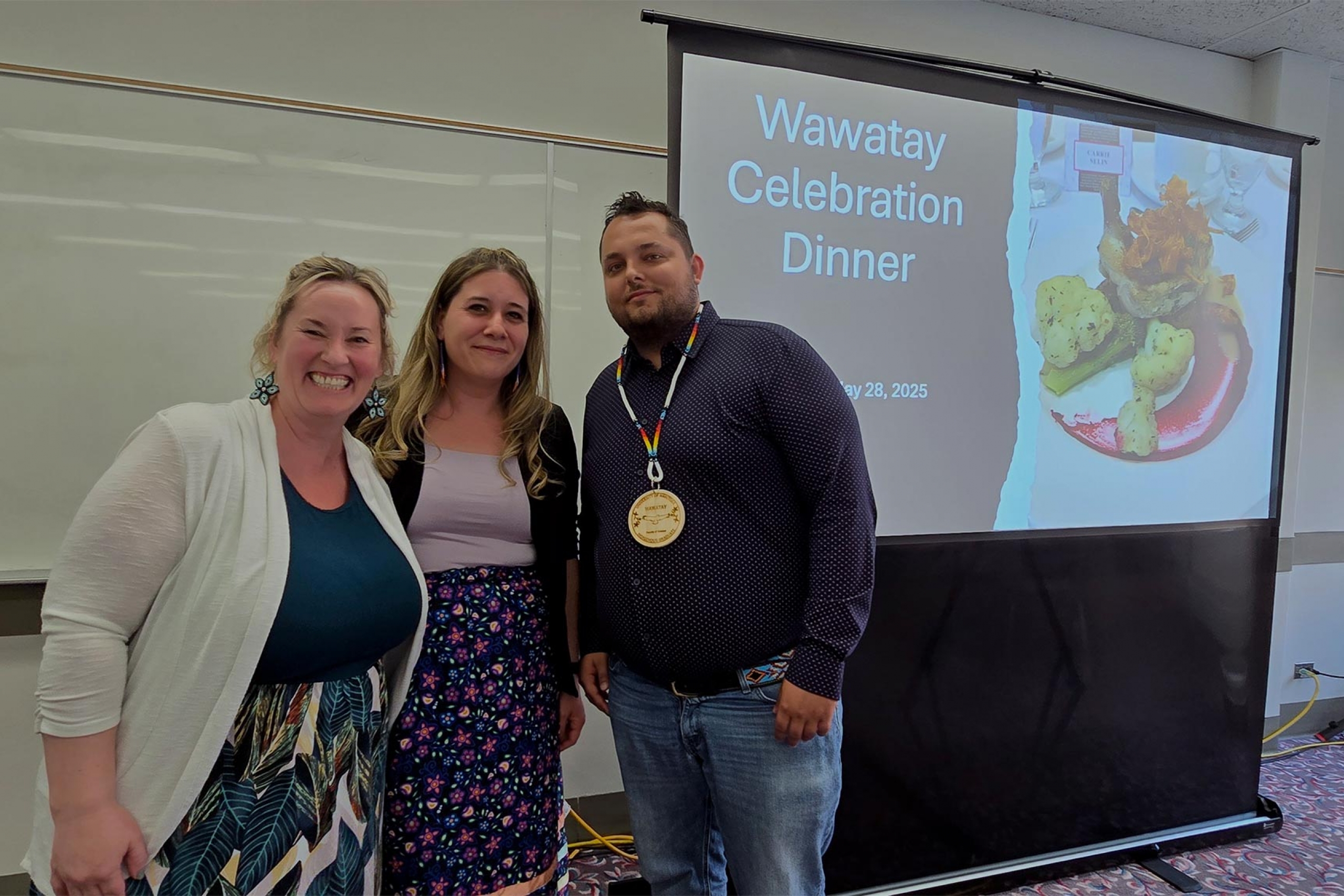 Carrie Selin, Melanie Lalonde and Brandon Wozniak smiling at the camera.