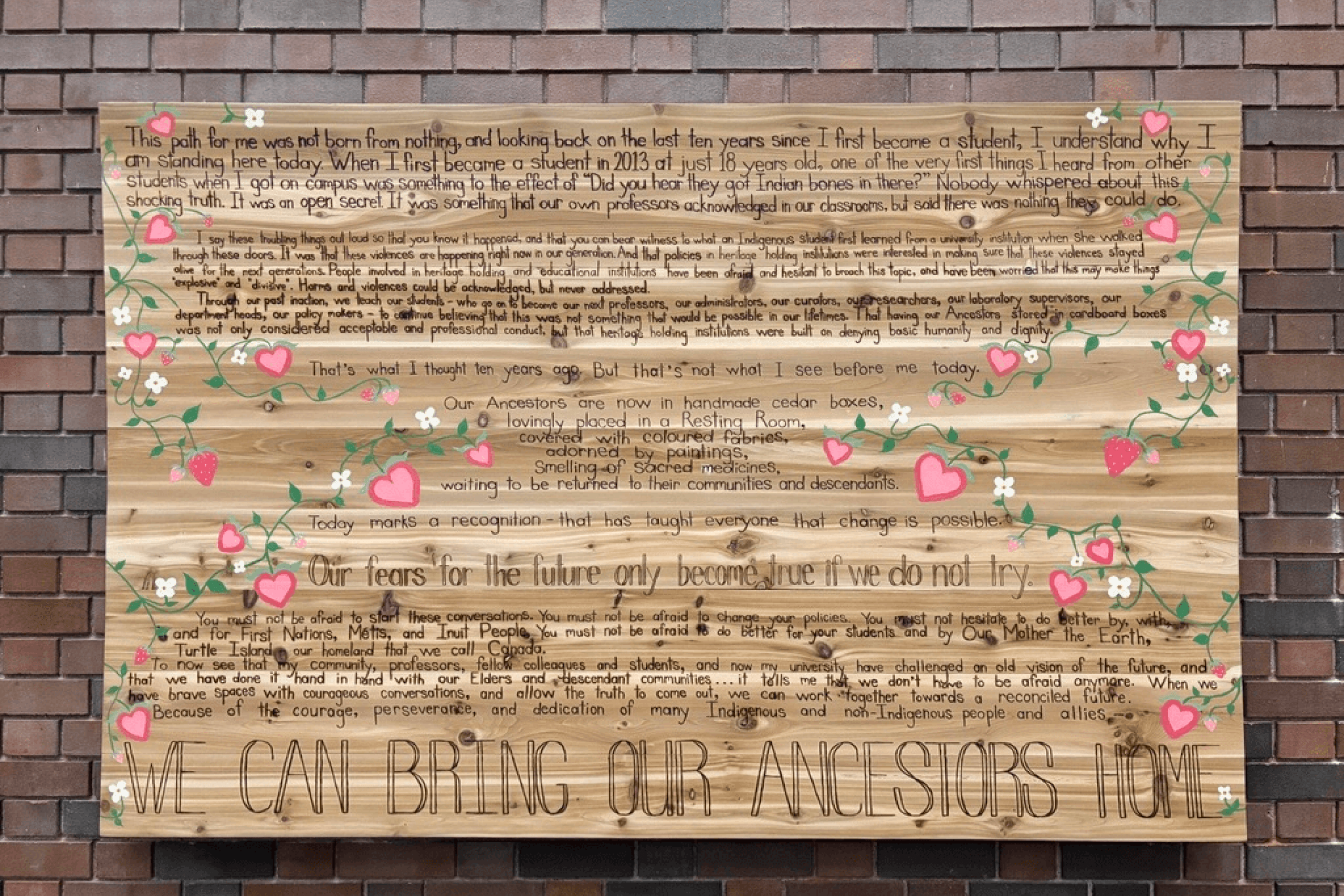 cedar board engraved with words and floral motifs.