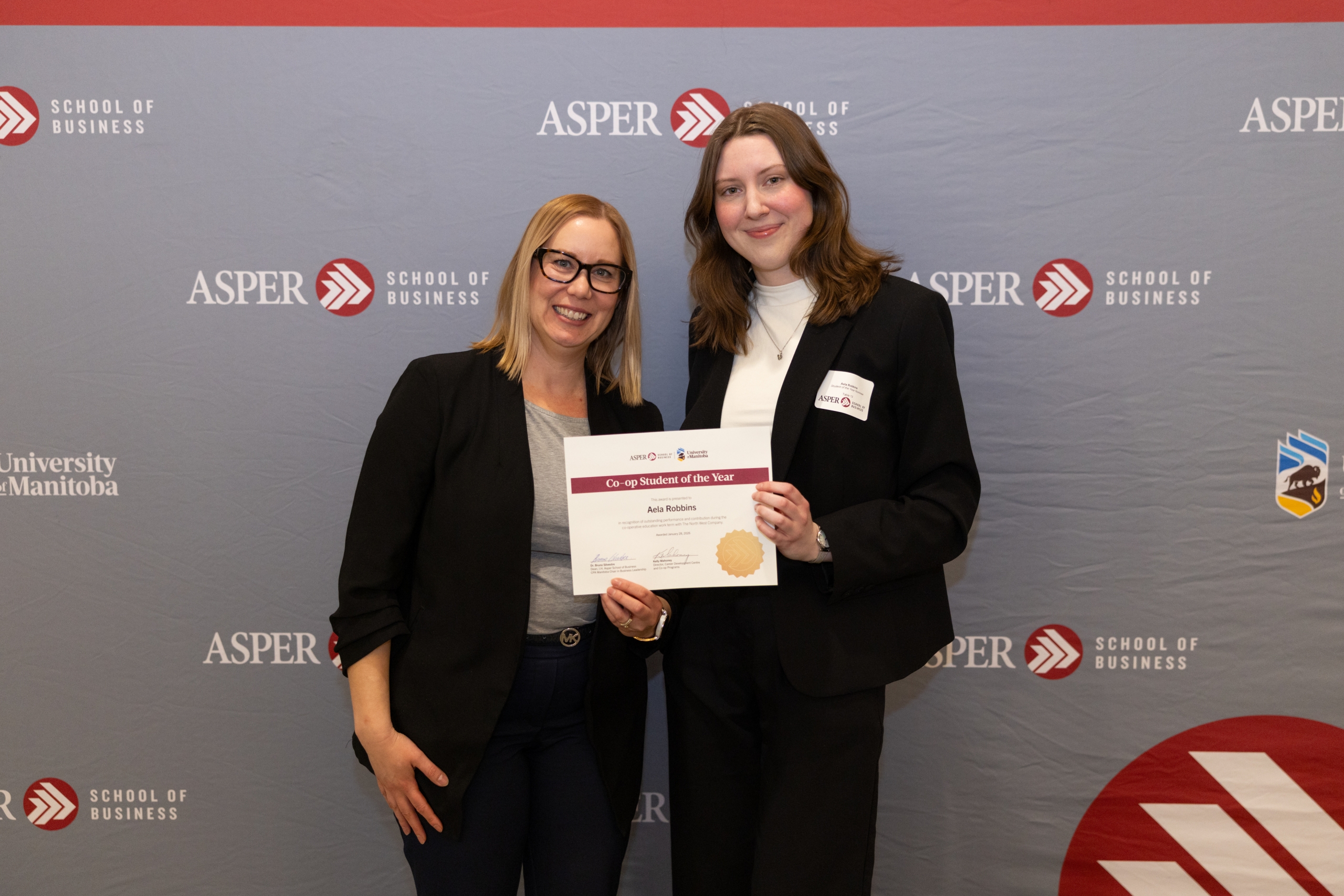 Aela Robbins and Charlene Glennson hold up a certificate for co-op student of the year