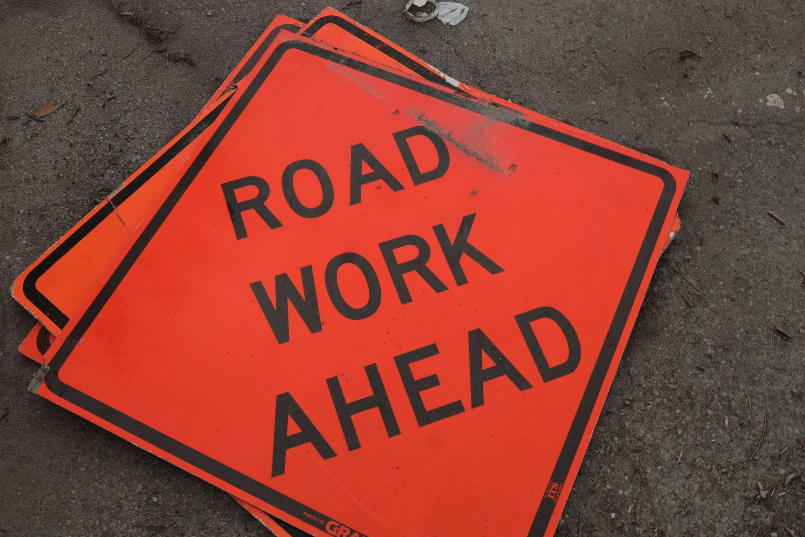 stackmo f road work ahead sign on ground