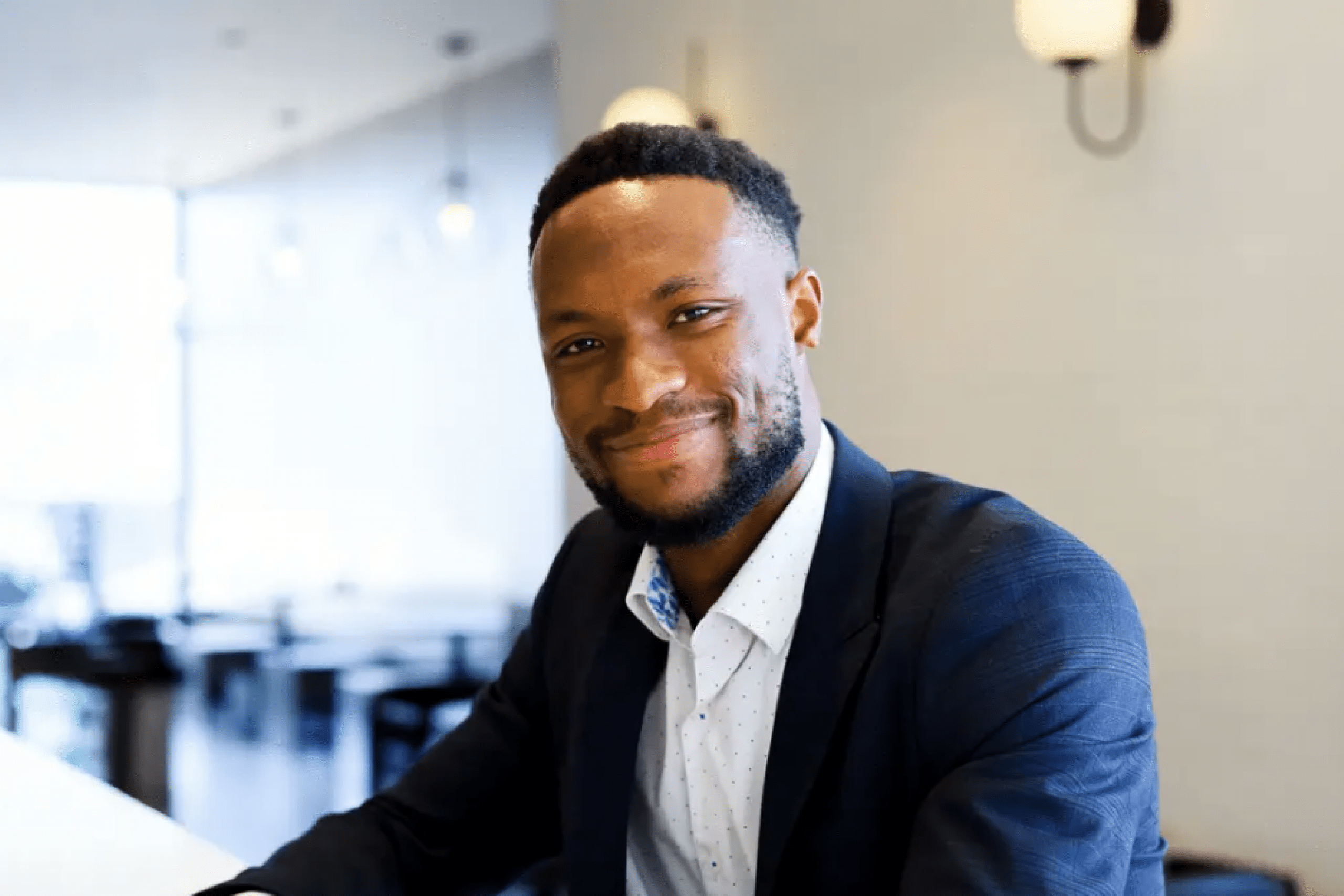 A man in a suit looking at the camera
