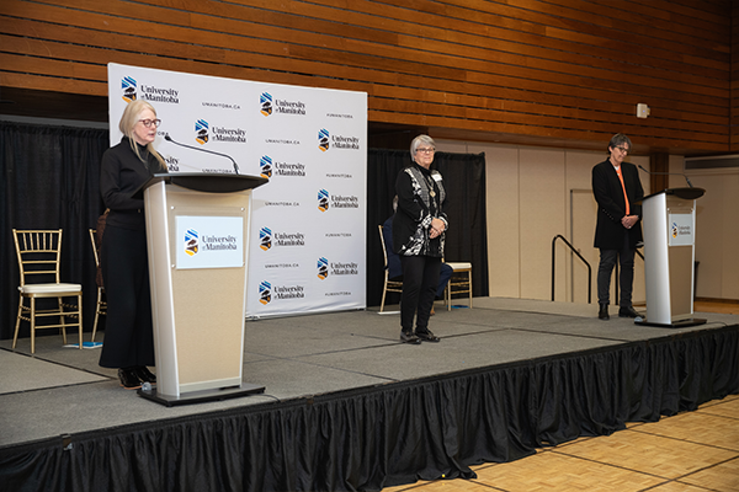 Dr. Lori Wallace stands as her emerita citation is read by Diane Hiebert-Murphy.