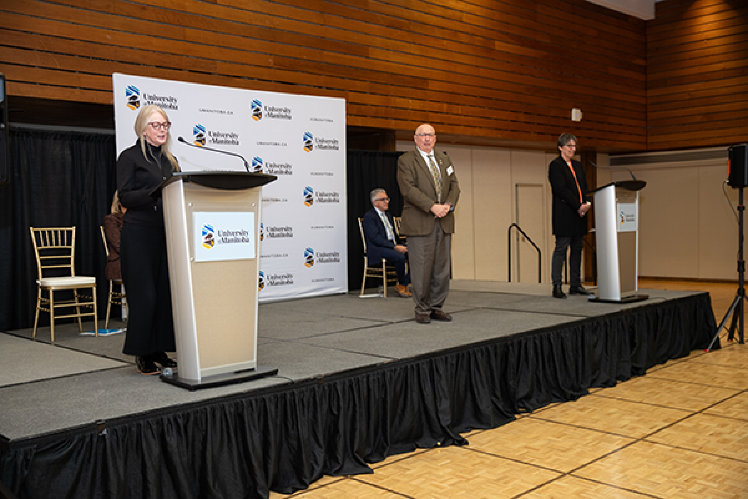 Dr. Brian Postl stands as Dr. Hiebert-Murphy reads his emeritus citation.